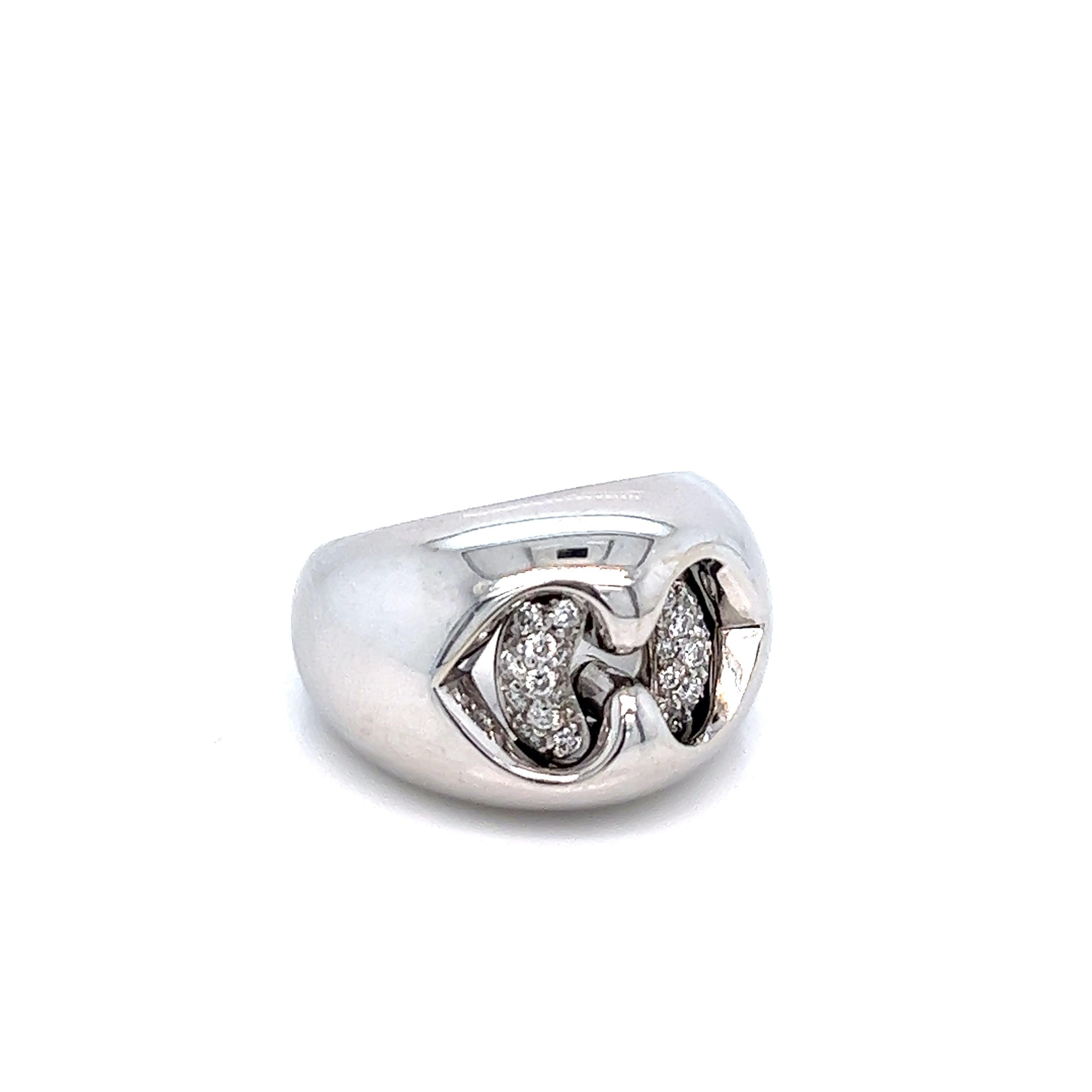 Bvlgari 18 karat white gold band ring with diamonds weighing approximately 0.18 carat. Marked: Bvlgari / 750 / Made in Italy. Total weight: 12.5 grams. Size 4.25-4.5. Thickest band width: 1.4 cm. 