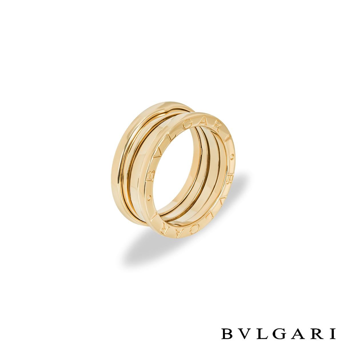 A classic 18k yellow gold ring by Bvlgari from the B.Zero1 collection. The ring comprises of 3 spiral design bands with the iconic 'Bvlgari Bvlgari' logo engraved around the outer edges. The ring is a UK size M/ USsize 6/ EU size 52 and has a gross