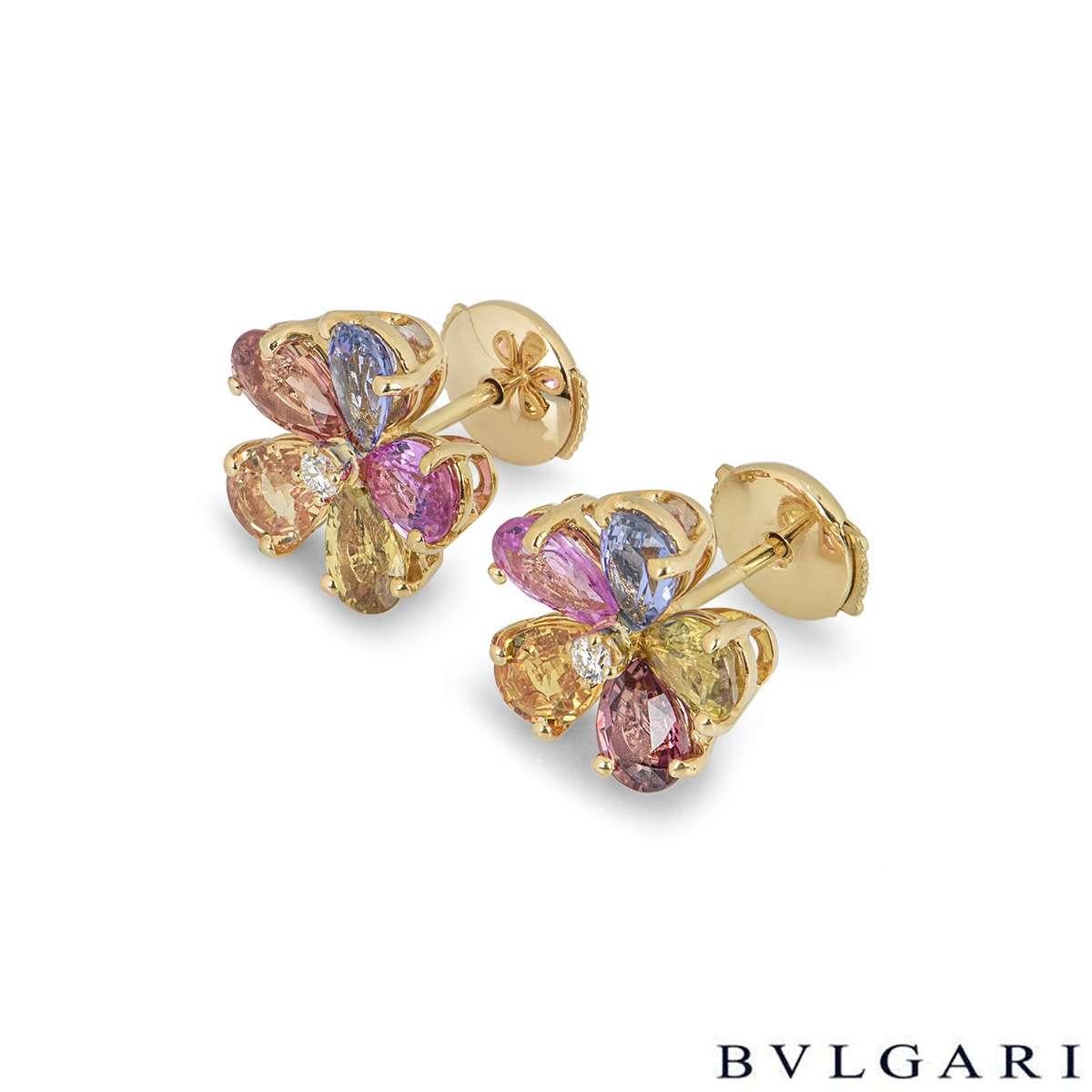 A gorgeous pair of 18k yellow gold flower earrings by Bvlgari. The earrings each feature a single round brilliant cut diamond in the centre surrounded by 5 multi coloured pear shaped sapphires. The diamonds have a total weight of approximately