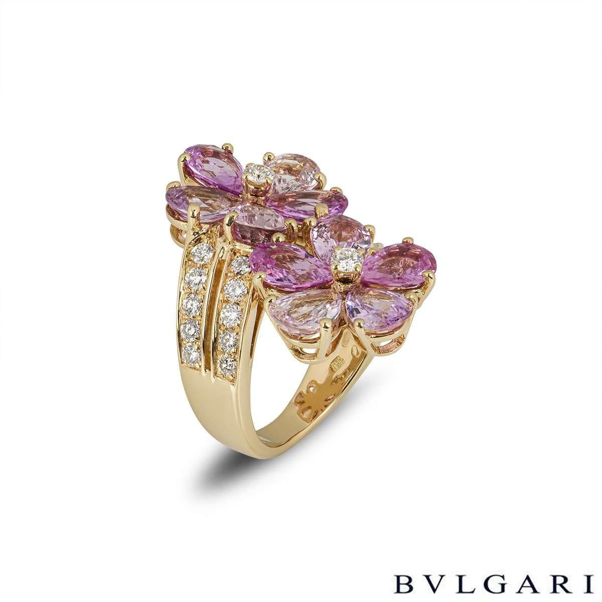 A beautiful 18k yellow gold, diamond and sapphire ring by Bvlgari from the Sapphire Flower collection. The ring comprises of 2 flower motifs composed of 10 fancy coloured pear cut sapphires as petals with 20 round brilliant cut diamonds in a pave