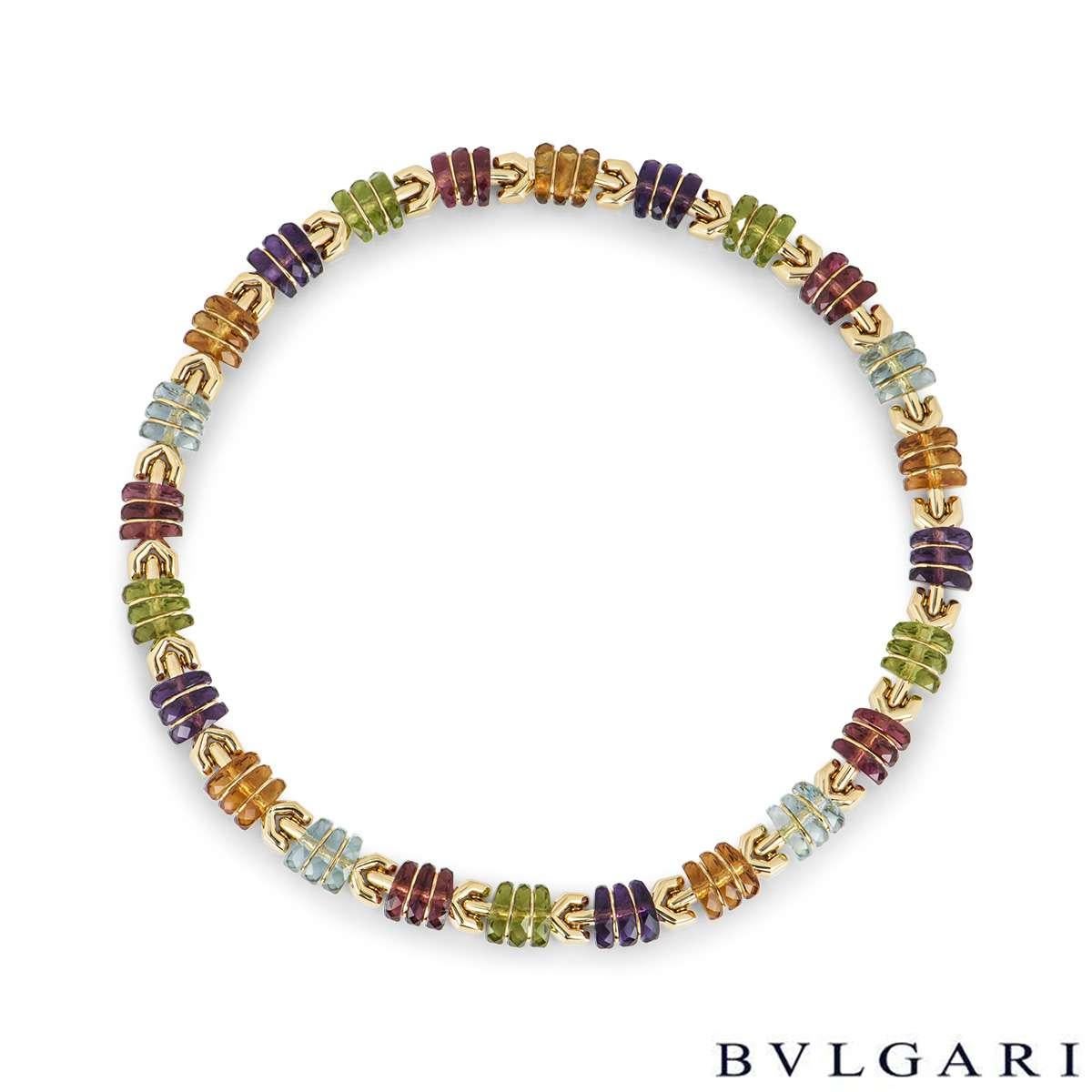 An eye-catching 18k yellow gold multi-gem set collar necklace by Bvlgari. The necklace is made up of 24 alternating gem-set links, featuring amethyst, citrine, aquamarine, tourmaline and peridot. The necklace measures 1cm in width and is 15.7 inches