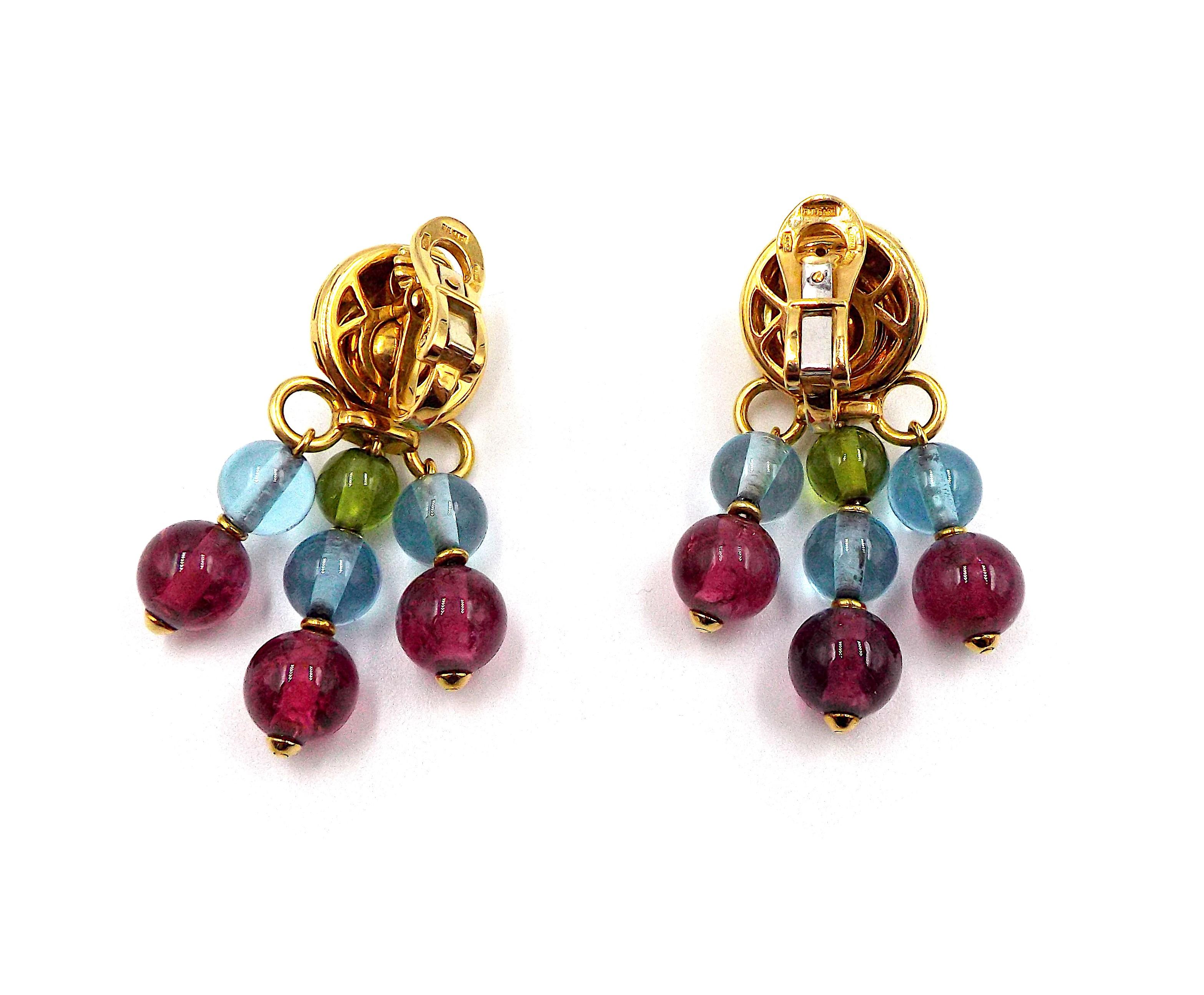 A pair of fancy colorful multi gemstone earrings made of 18K yellow gold. Each earring weighs 17.4 grams, length is approximately 1 5/8 inches, width is approximately 1 inch. Circa 1970s. Signed Bvlgari, stamped 750, Made in Italy, with Italian