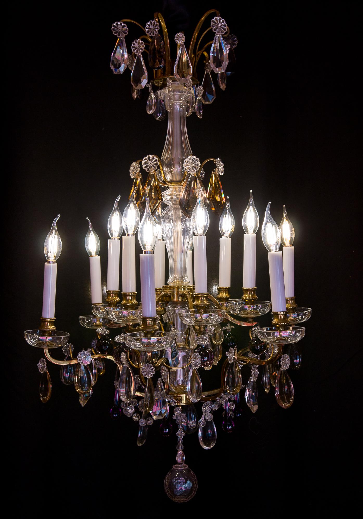 We are pleased to present you, beautiful ormolu and hand-cut French crystal chandelier.
Our chandelier is composed of twelve perimeter arm lights.
Excellent quality white, amethyst and amber colors hand-cut crystal pieces. One lovely hand-cut