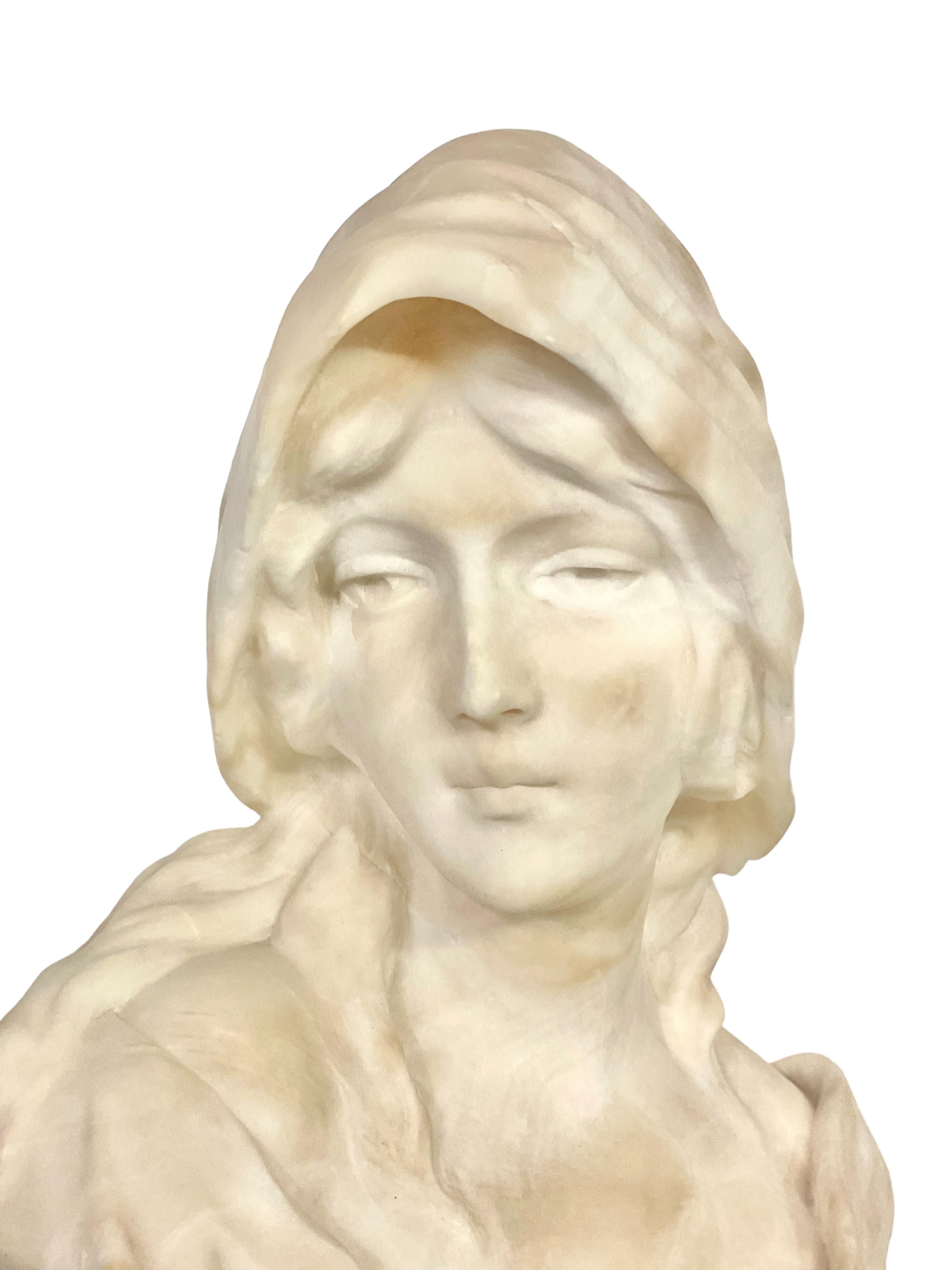 Introducing a mesmerizing alabaster bust by renowned sculptor Georges Morin (1874-1950). This exquisite piece showcases a young woman in a delicately buttoned bustier, revealing a graceful neckline and long, gently wavy hair tucked under an elegant