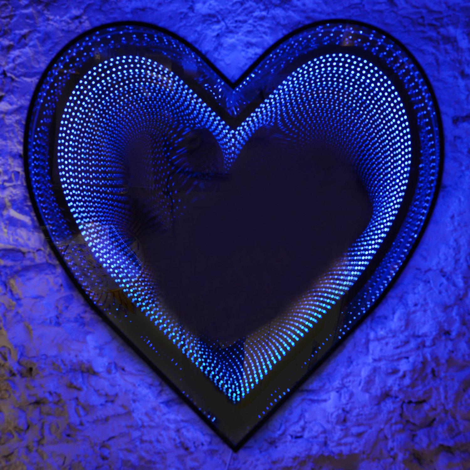 Mirror By Heart made with LED lights with mirrored glass 
and plexiglass creating an infiny mirrored effect through 
a heart shape. With colors changing option with remote control. 
Limited Edition of 15 pieces by Raphael Fenice.