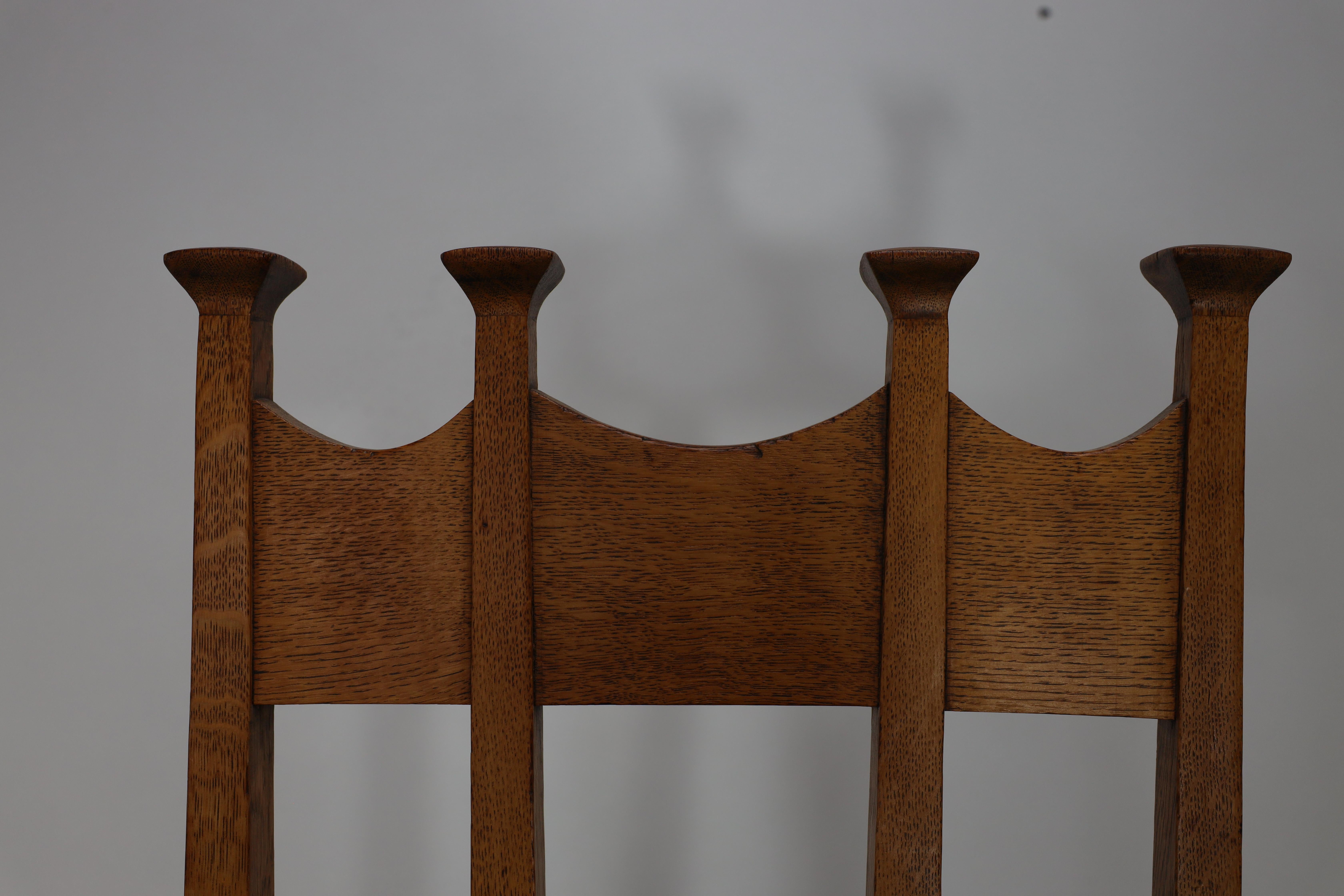 Early 20th Century J S Henry Arts & Crafts oak dining chair with throne like caps & a sweeping back For Sale