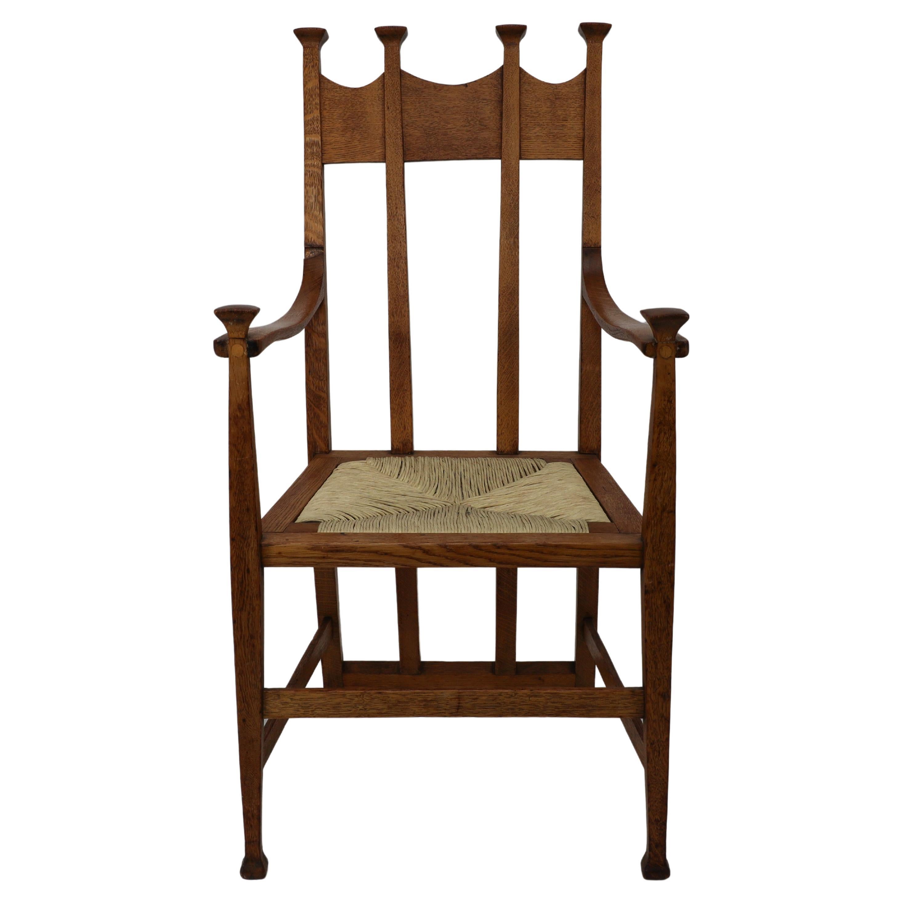 George Montague Ellwood. Made by J S Henry. An Arts and Crafts oak dining chair with throne like capped tops and sweeping back supports standing on tapering square legs. One available the price quoted £2800 is for one armchair.
