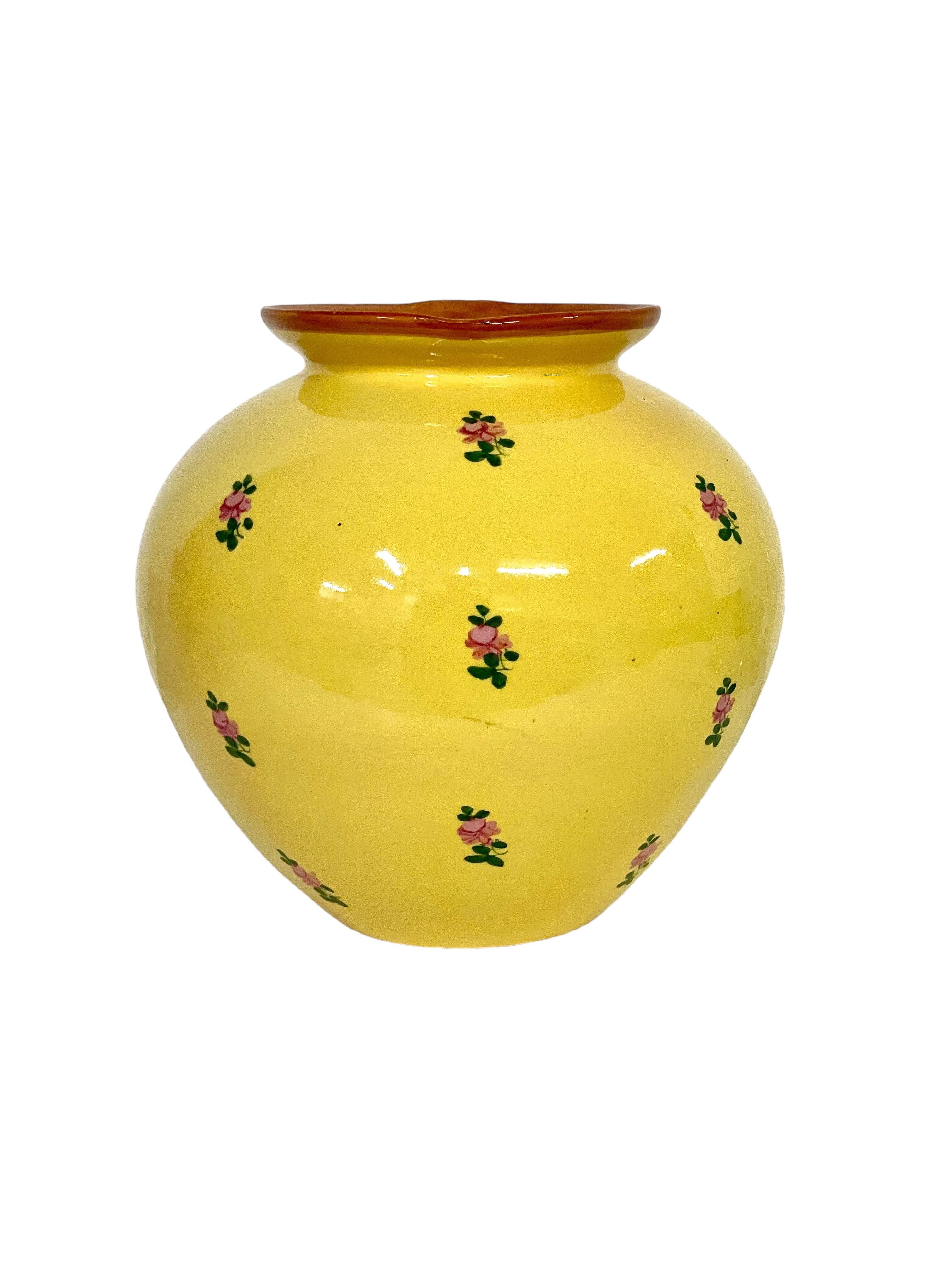 A bright and cheerful ceramic jug, ovoid in shape and glazed in vibrant yellow, with hand- painted rose buds and a contrasting rim. The jug is marked on its belly and stamped on its base with with the mark of Jérôme Massier (1830-1916) of Vallauris