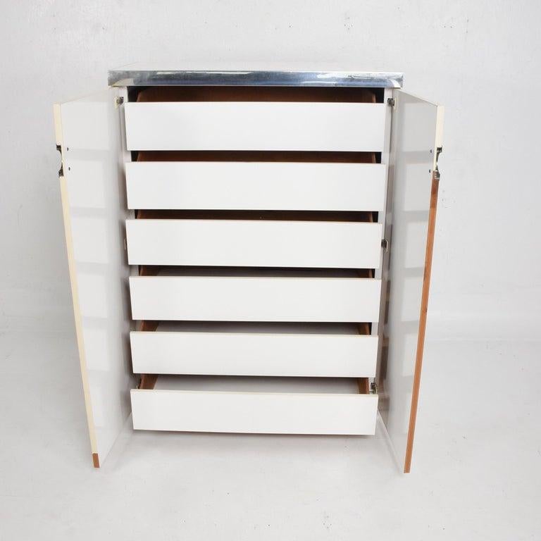For you: 1970s modern French designer late Pierre Cardin wardrobe cabinet chest of drawers made in formica, wood, aluminum and chrome-plated accents.
All drawers open and close easily. Maker Signed Pierre Cardin.
Measures: 50.88 tall x 19.13 depth