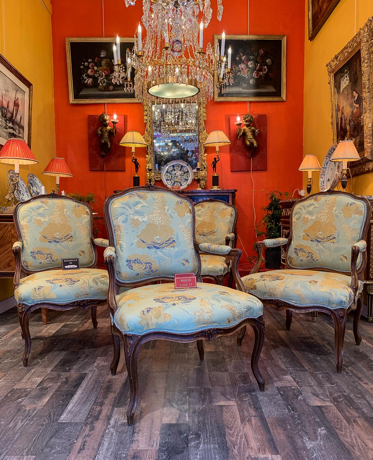 Stamped by Louis Delanois, Louis XV period set of 4 of large armchairs, circa 1765-1770.

A beautiful and rare set of 4 in large armchairs in beechwood with floral carving on its back and front seat. 
Our armchairs are in good condition and there