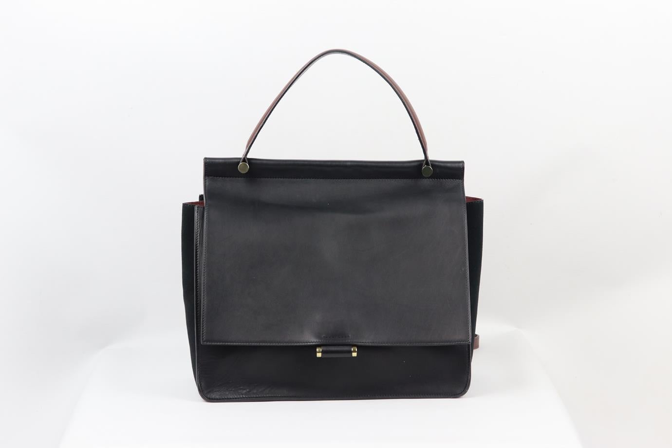 By Malene Birger suede andleather shoulder bag. Made from soft black leather and suede with burgundy shoulder strap and handle, it opens to a large internal compartment with additional pockets. Black, burgundy and gold. Magnetic snap fastening at