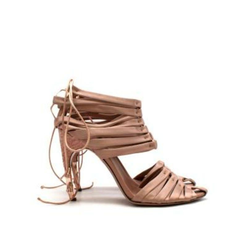 Gucci by Tom Ford Blush Satin Corset Sandals
 
 
 
 - Soft satin body 
 
 - Gladiator style panels 
 
 - Rose gold metal and embossed leather stiletto heel
 
 - Almond toe 
 
 - Ankle fastening 
 
 - Fully lined with pink leather 
 
 
 
 Materials:
