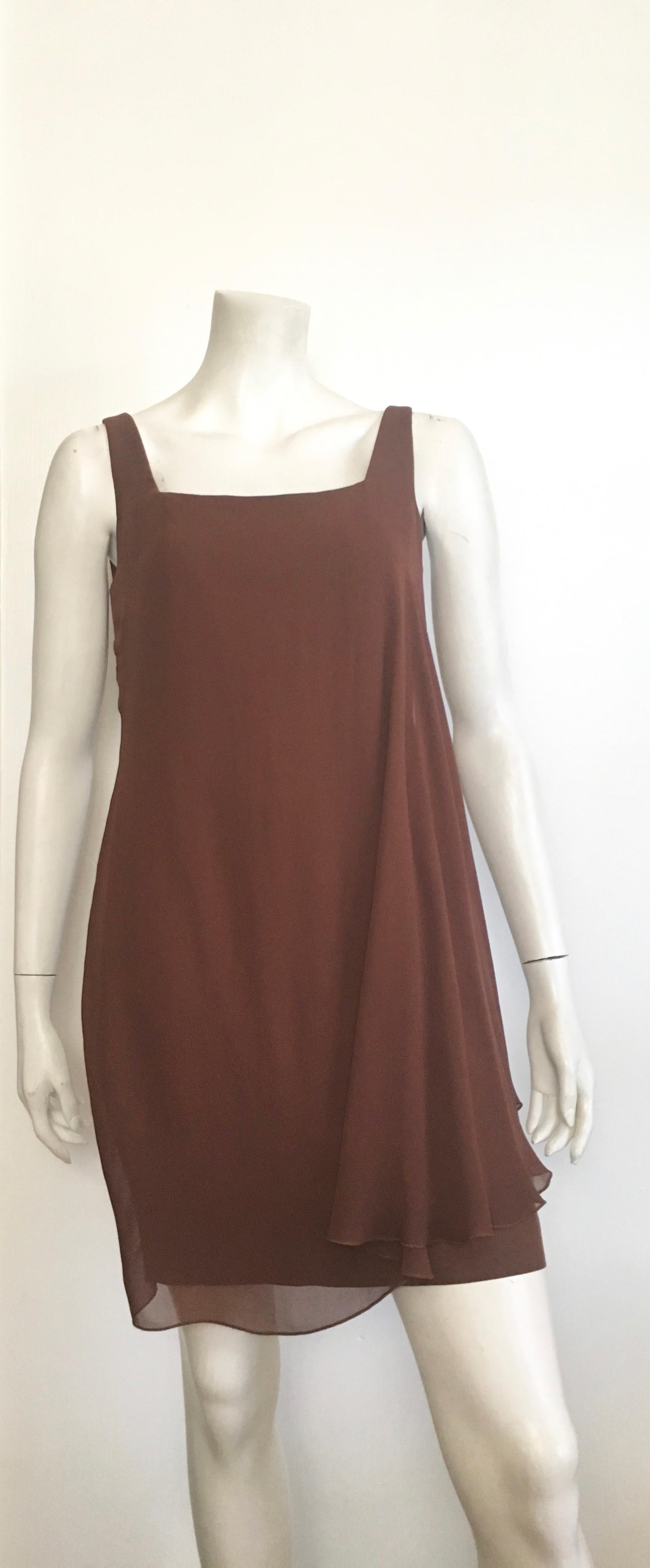 Byblos for Isaackson's store in Atlanta 1980s brown sleeveless sheath dress is an Italian size 42 and fits a size 6.  Byblos is an iconic Italian brand that was started in 1973 and had fashion designers such as Gianni Versace designing for this