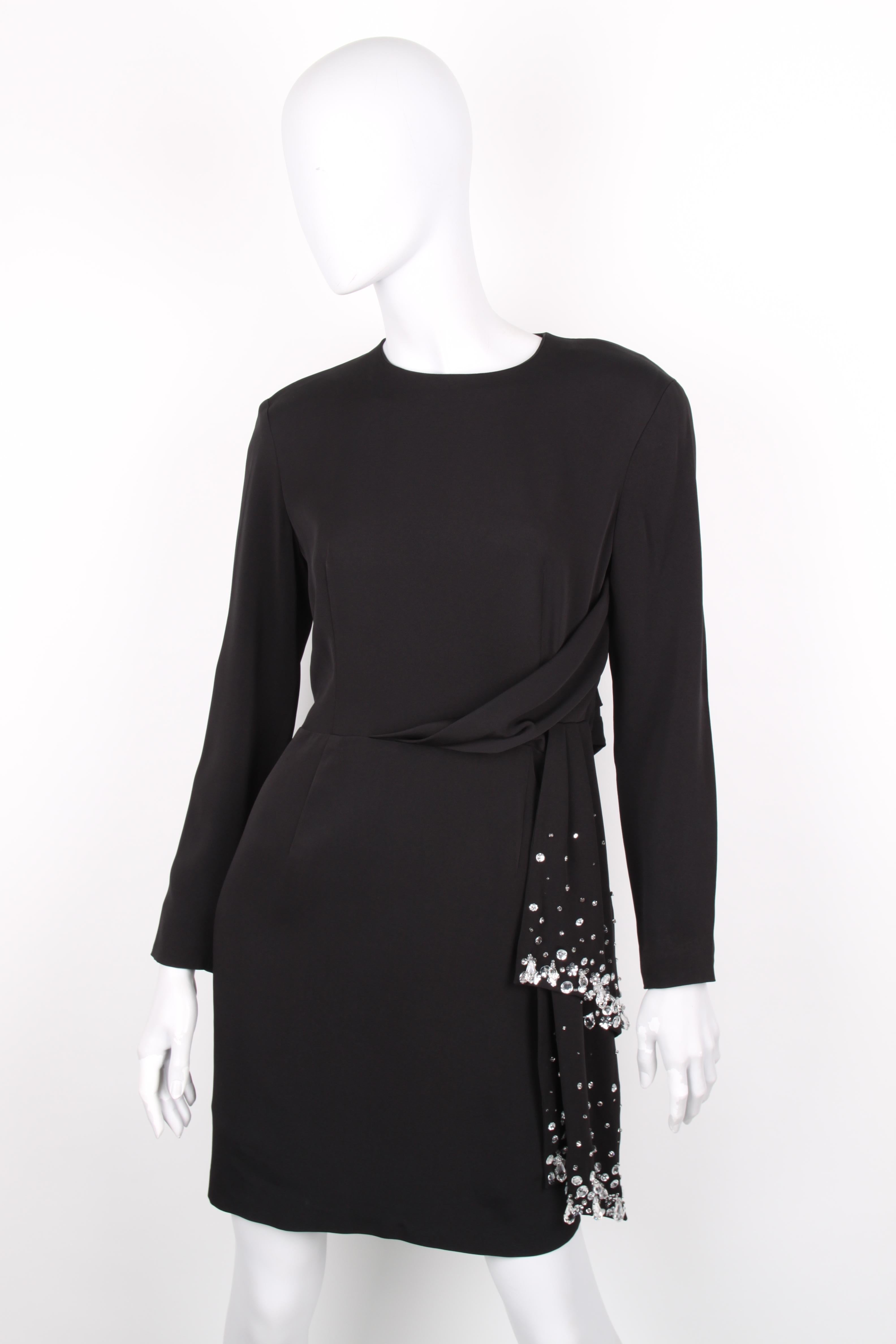 Byblos Black Embellished Asymmetrical Longsleeve Tied Waist Dress.

Featuring an astounding design in black, this evening dress carries the House’s maximal aesthetic. It has a classic synched silhouette with front back-zip closure, long sleeves and