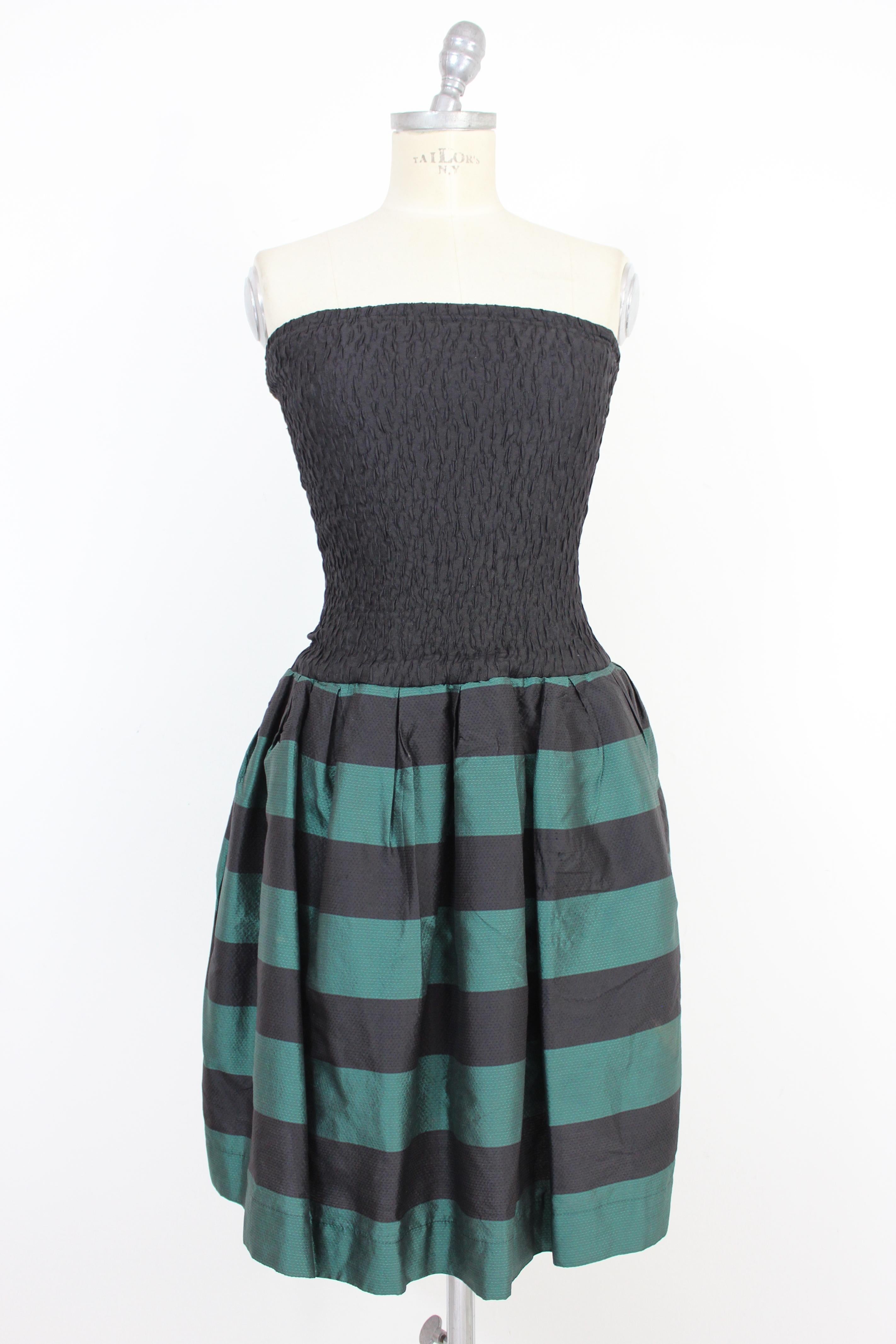 Byblos 90s vintage woman dress. Short dress, black elastic bodice, green and black striped balloon skirt. Pockets on the hips. Bodice fabric 80% silk 20% elastomer, the fabric of the skirt 100% silk. Internally lined 100% cotton. Made in