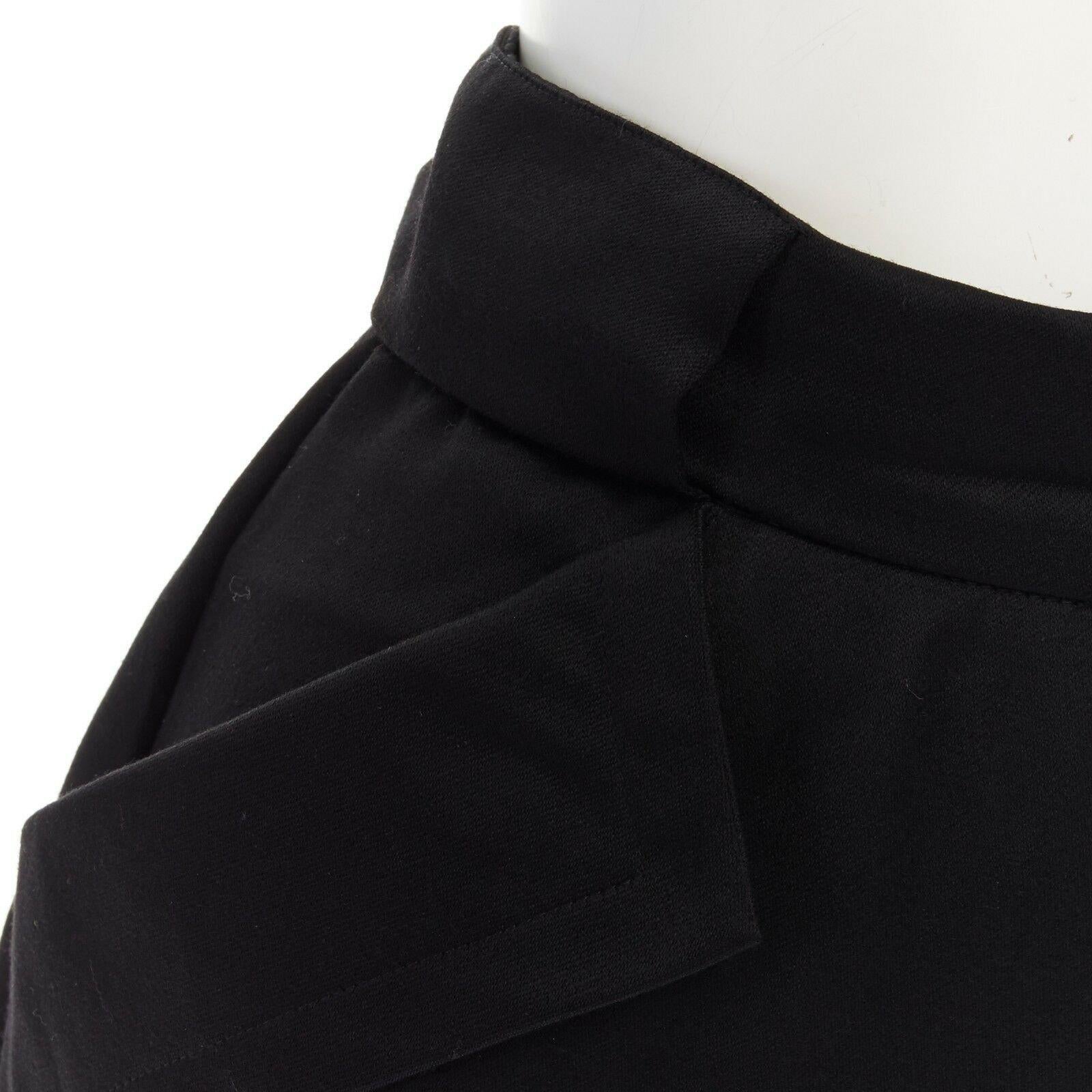 BYBLOS ITALY black dual fold over flap pocket attached panel back skirt IT38 
Reference: CRTI/A00241 
Brand: Byblos 
Material: Unknown 
Color: Black 
Pattern: Solid 
Extra Detail: Feels like wool. Black. Dual fold over detail pocket at waist.