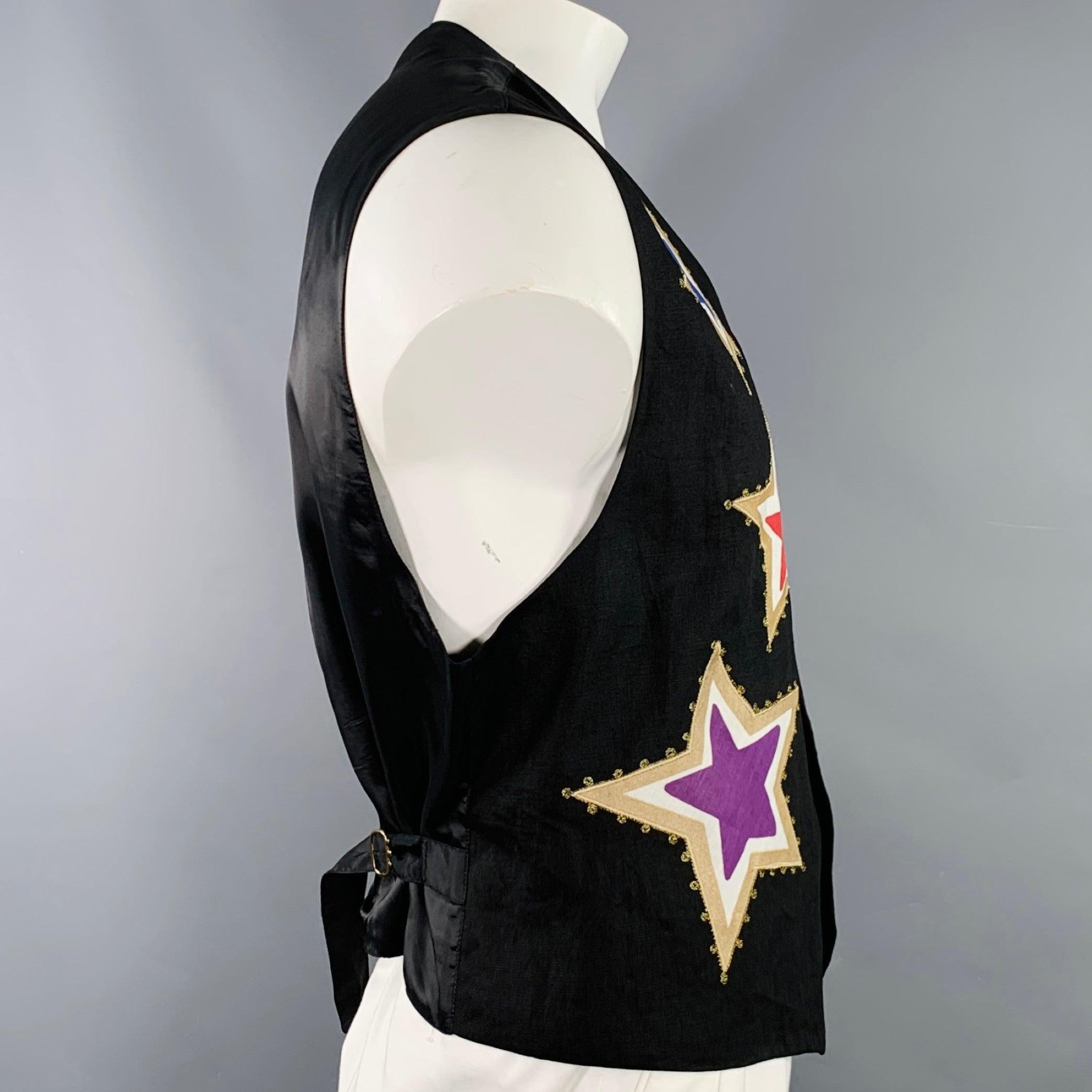 BYBLOS vest
in a black linen featuring multi-color embroidered stars and floral motif, V-neck, and button closure. Made in Ital.Good Pre-Owned Condition. Multiple minor marks on stars, mark at neck inside of garment. 

Marked:   IT 52