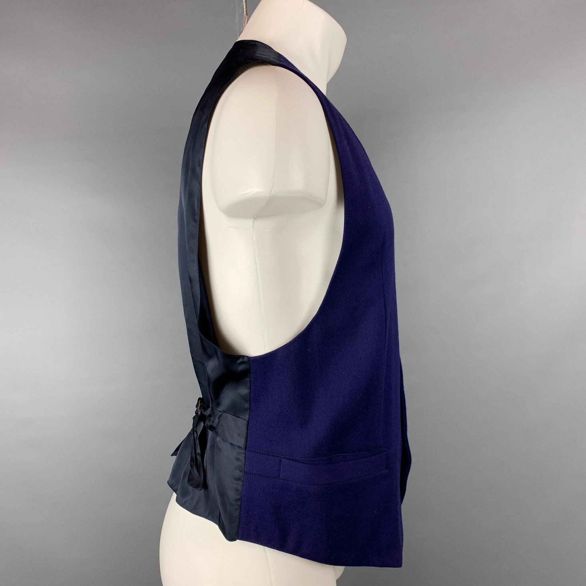 BYBLOS vest comes in a purple wool with a full liner featuring slit pockets, back belt, and a buttoned closure. Made in Italy.Very Good
 Pre-Owned Condition. 
 

 Marked:  IT 52 
 

 Measurements: 
  
 Shoulder: 16 inches Chest: 40 inches Length: 22