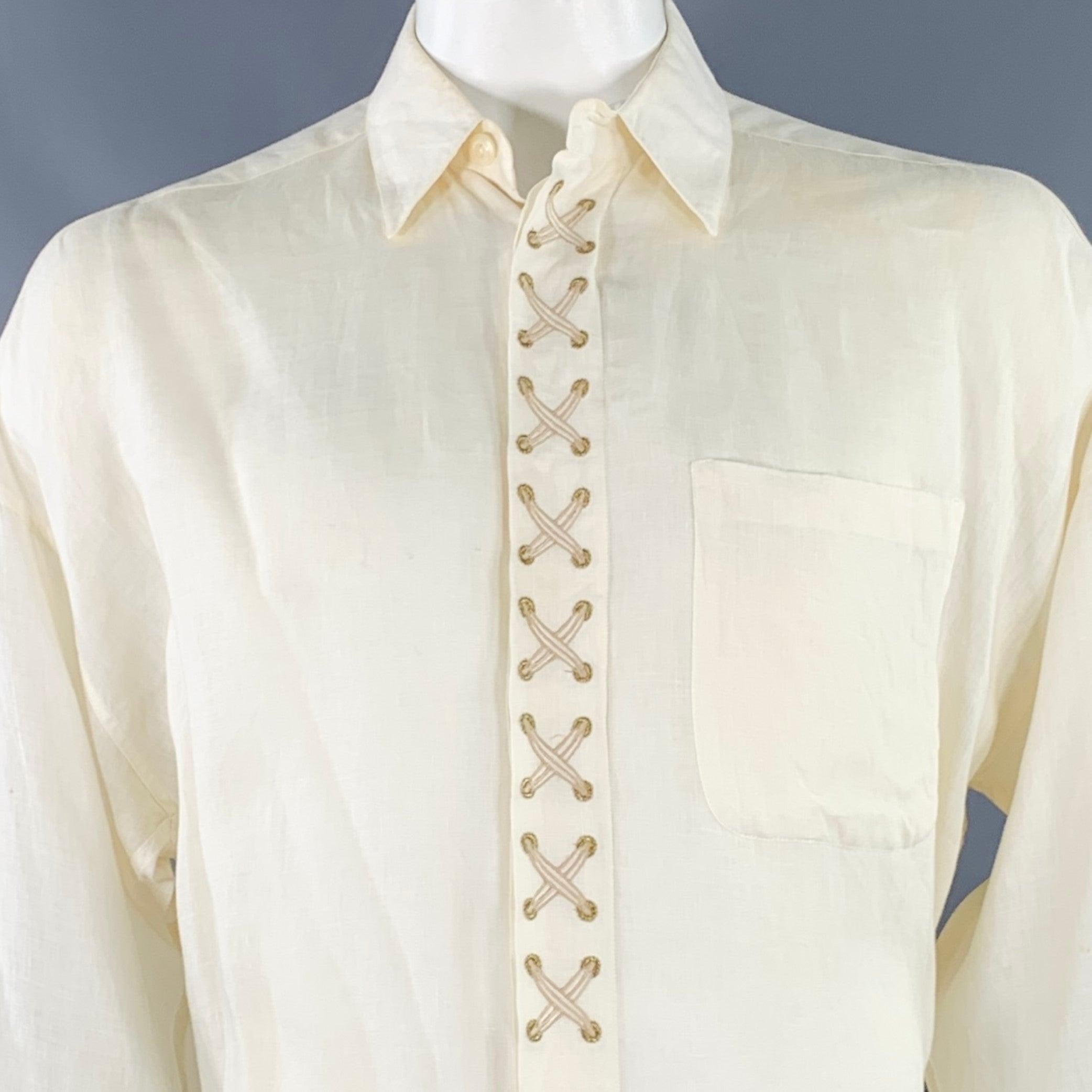 BYBLOS long sleeve shirt
in a cream woven linen featuring a point collar, one pocket, and hidden button closure with embroidered lace-up details. Made in Italy.Good Pre-Owned Condition. Moderate hard-to-see marks, please check photos. 

Marked:   IT