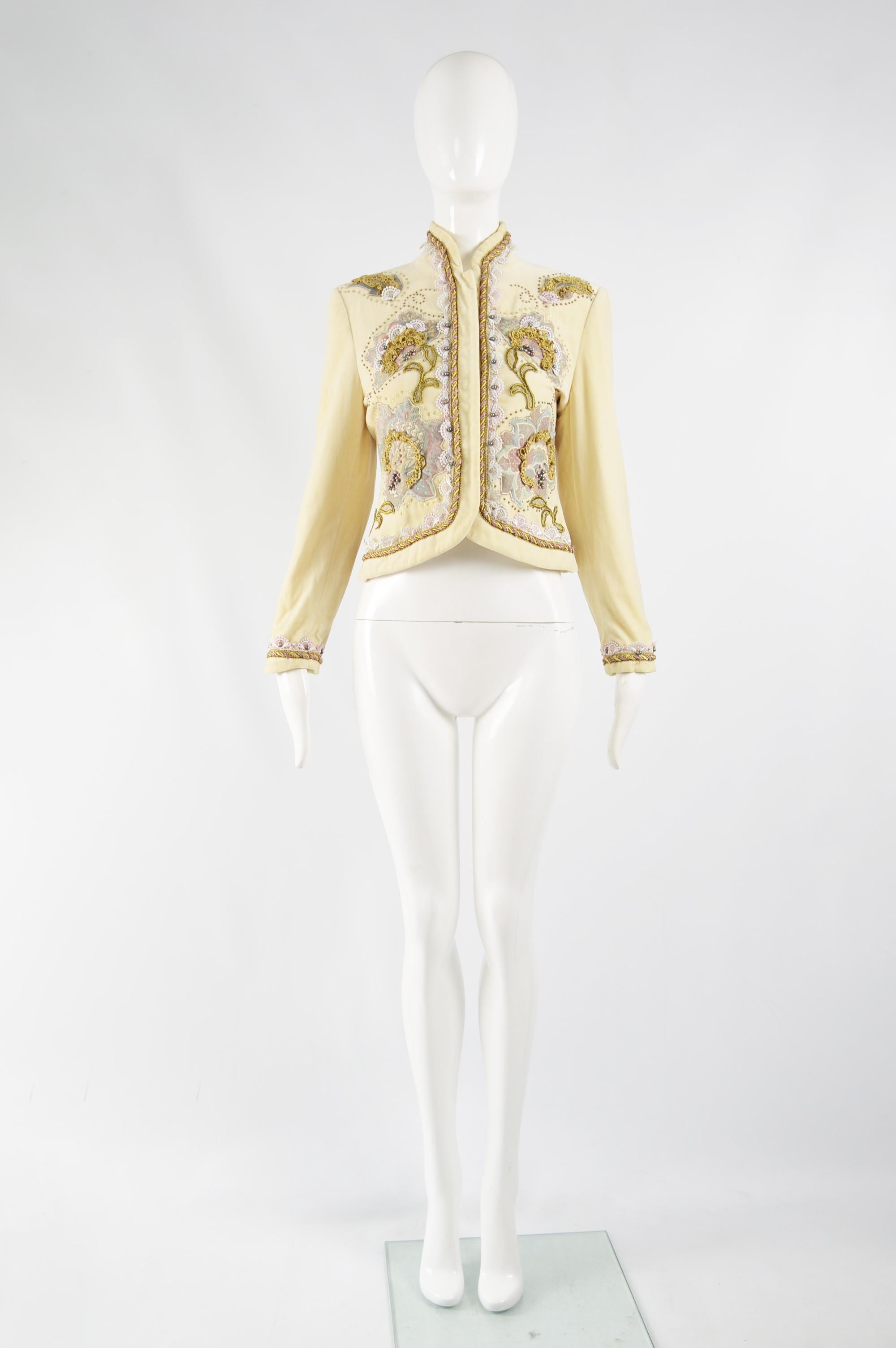 A fabulous vintage womens jacket from the 80s by luxury Italian fashion house, Byblos. In a cream velvet with floral tapestry appliques, beads, sequins and a broderie anglaise trim. Perfect for a party or evening event. 

Size: Marked IT 40 which