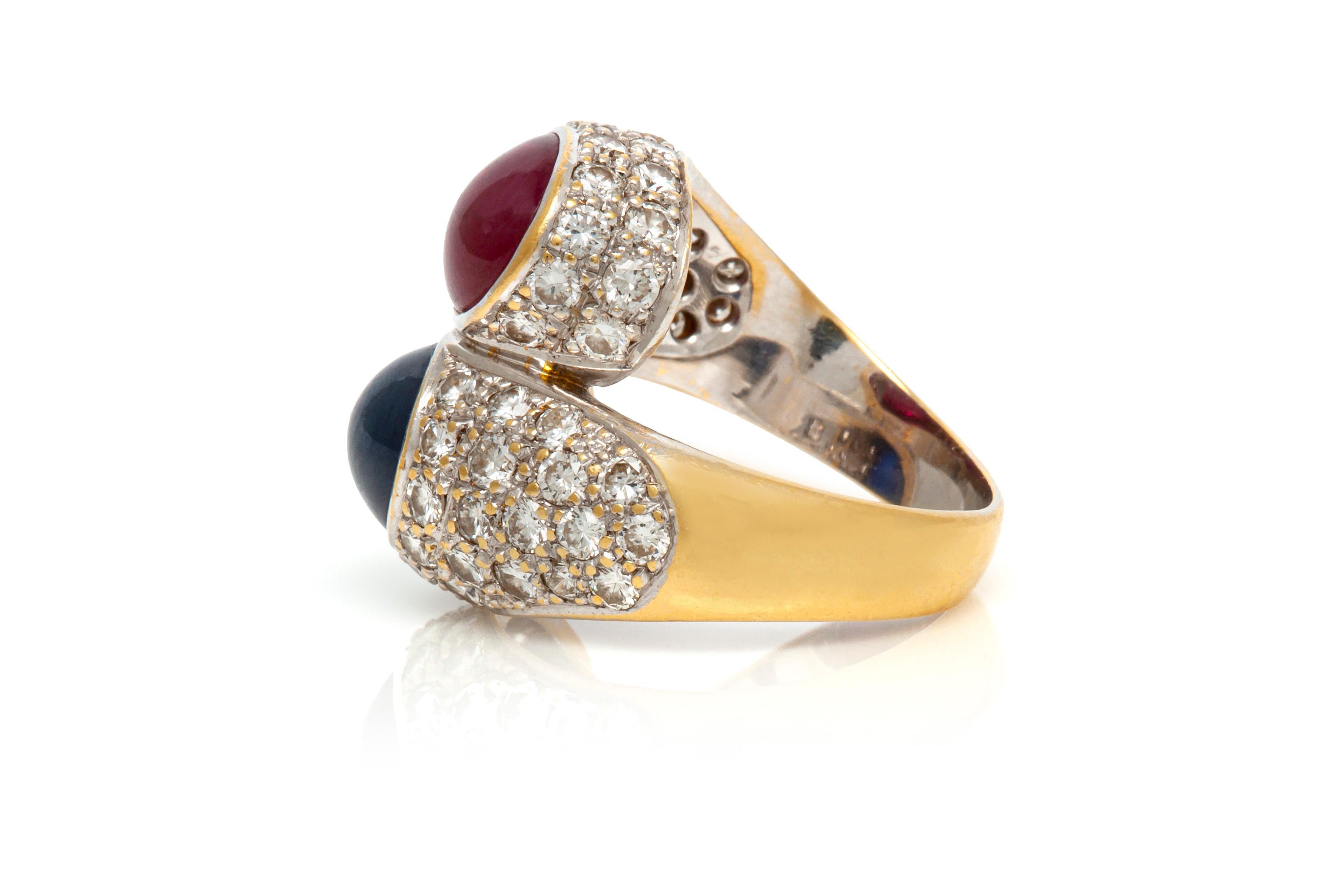Ring finely crafted in 18K white gold with Cabochon Ruby and Sapphire surrounded with diamonds. 
The Cabochon Sapphire weighing approximately 4.00 carat.
The Cabochon Ruby weighing approximately 4.00 carat. 
The diamonds weighing approximately 3.20