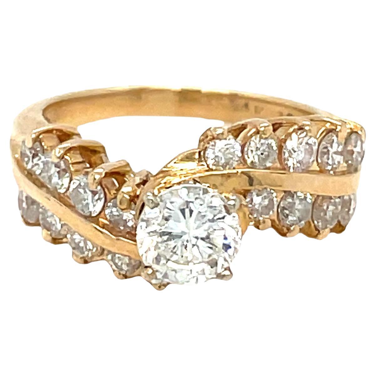 Stunning bypass diamond engagement ring captures sophistication and elegance. The curving twisted shank adding a touch of uniqueness and symbolizing the journey of love. Crafted in 14K yellow gold, this beautiful ring features four prong-set round