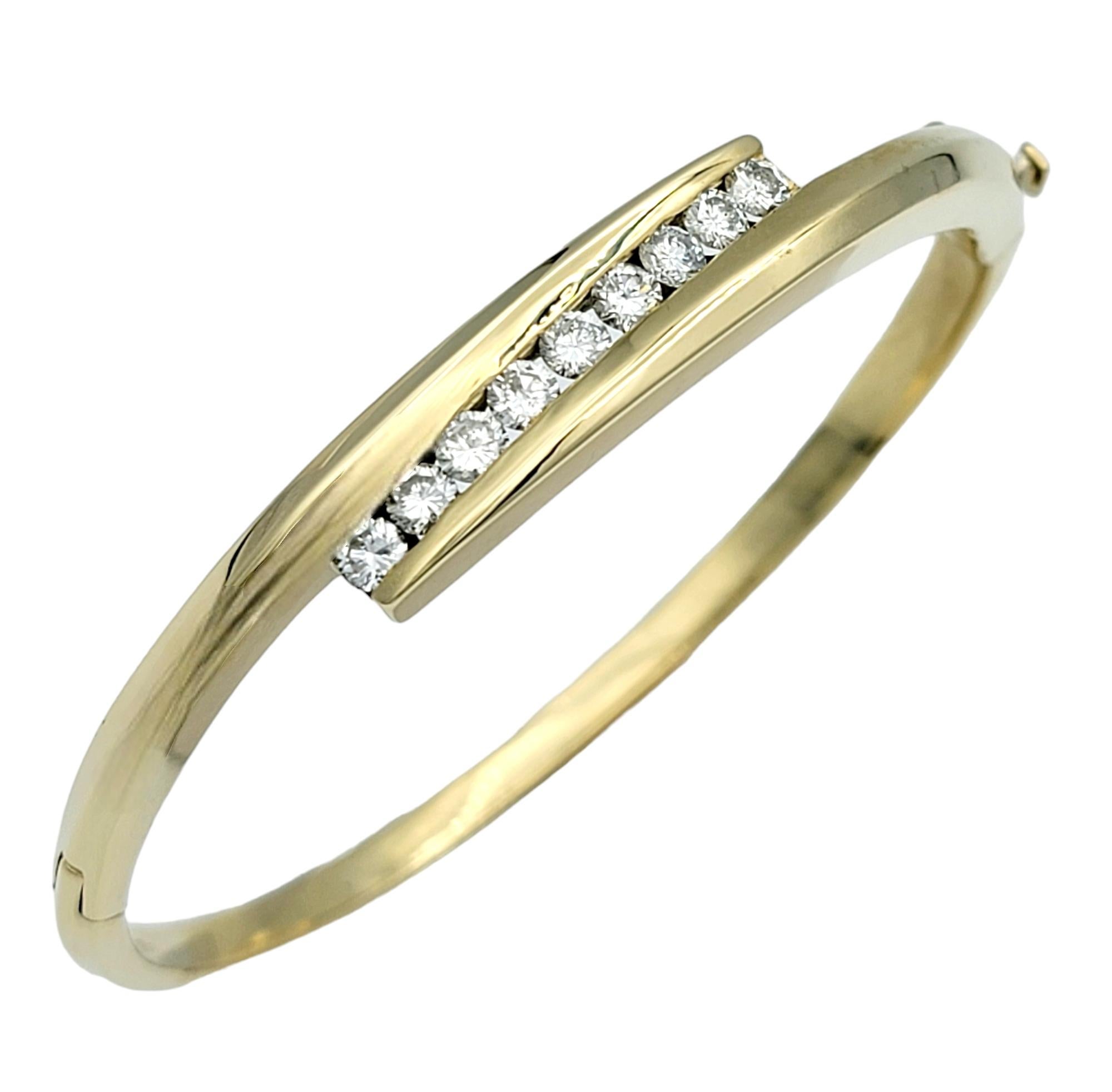 The inner circumference of this bracelet measures 6.75 inches and will comfortably fit up to a 6.5 inch wrist. 

This diamond bypass-style hinged bangle bracelet is a sophisticated accessory crafted in 14 karat yellow gold. The bypass design gives