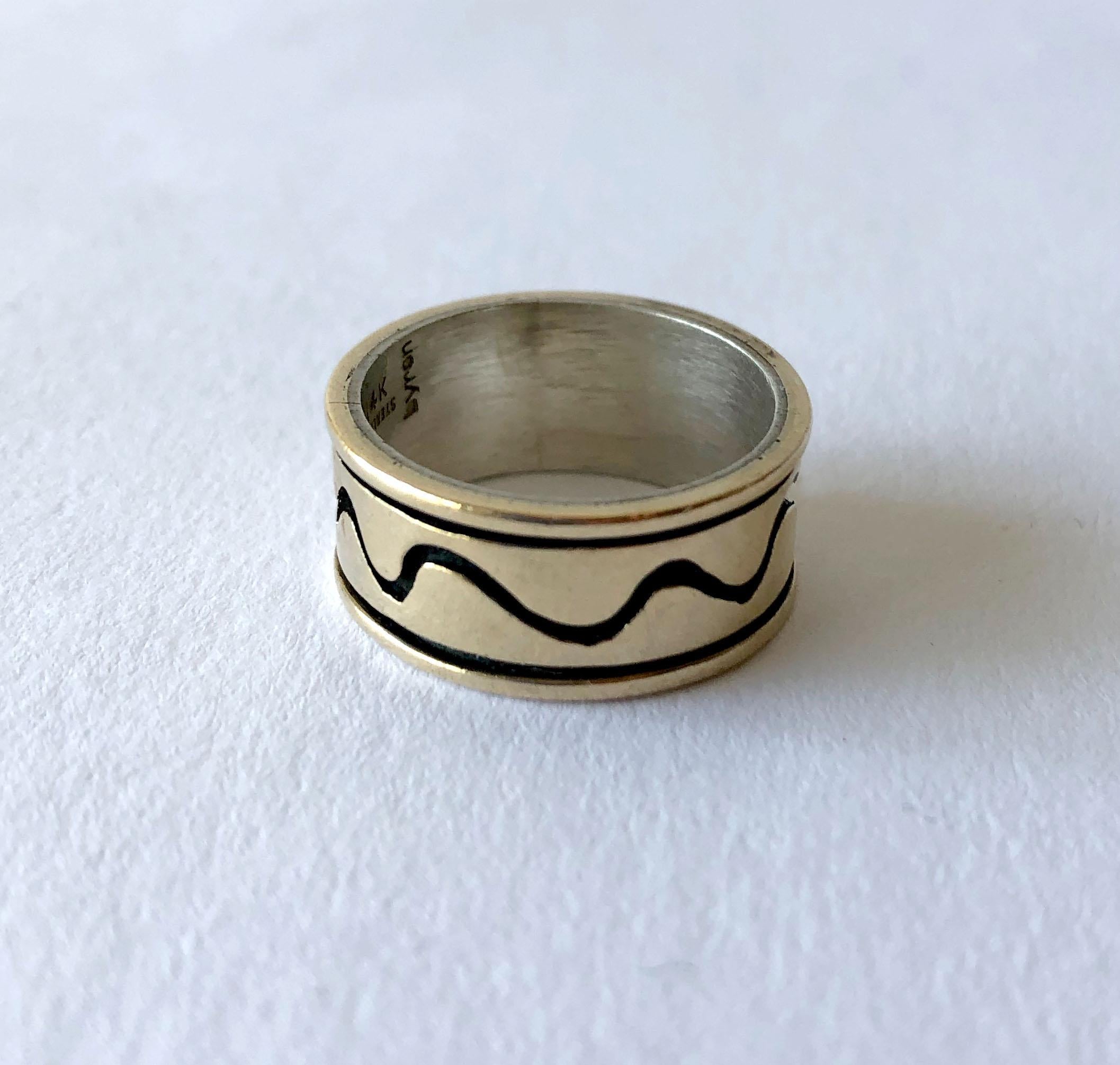 Sterling silver and 14k gold ring with squiggle design signed Byron, circa 1960s.  Ring is a finger size 8 and is 3/8