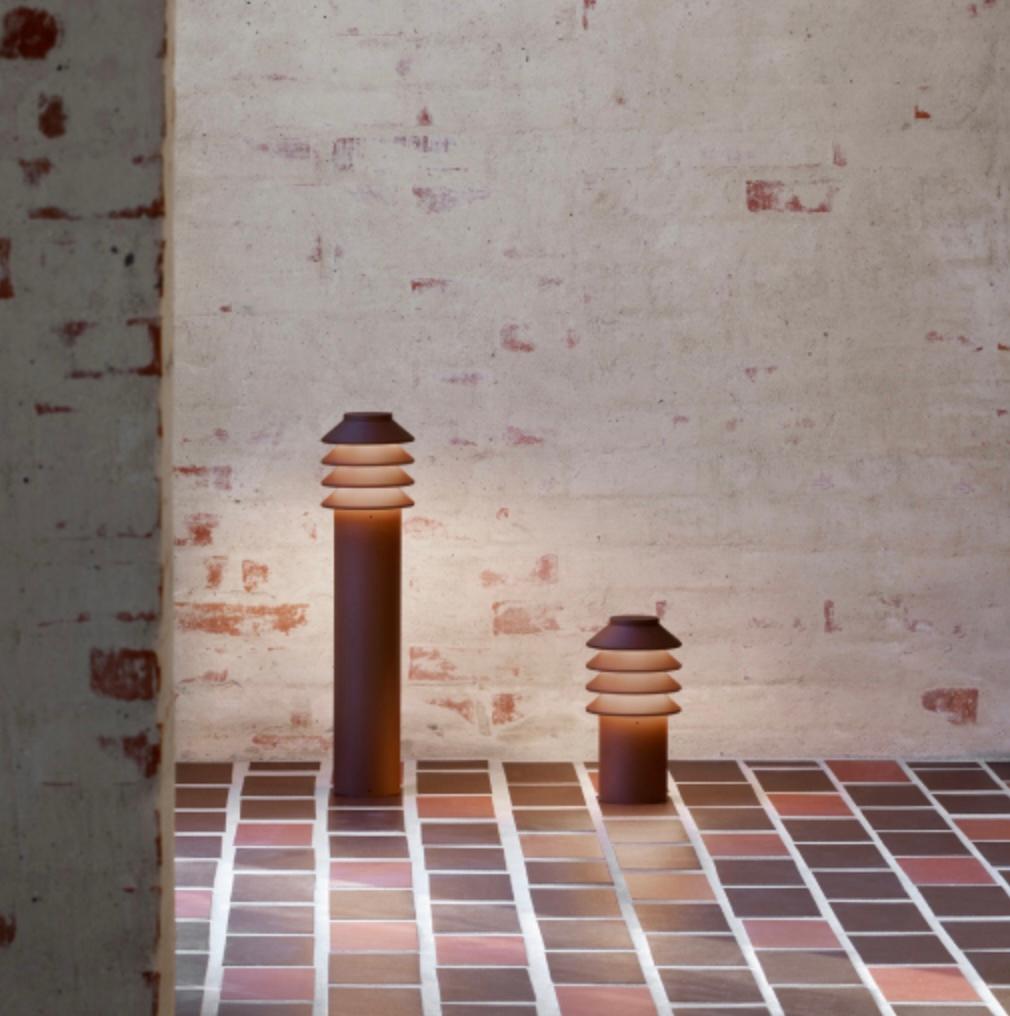 'Bysted Garden Long' Outdoor Bollard Light for Louis Poulsen in Corten Red

'Bysted Garden' is a downscaled version of Peter Bysted's award-winning bollard. Its four rings provide a gentle glow, while their white underside creates a reflection which