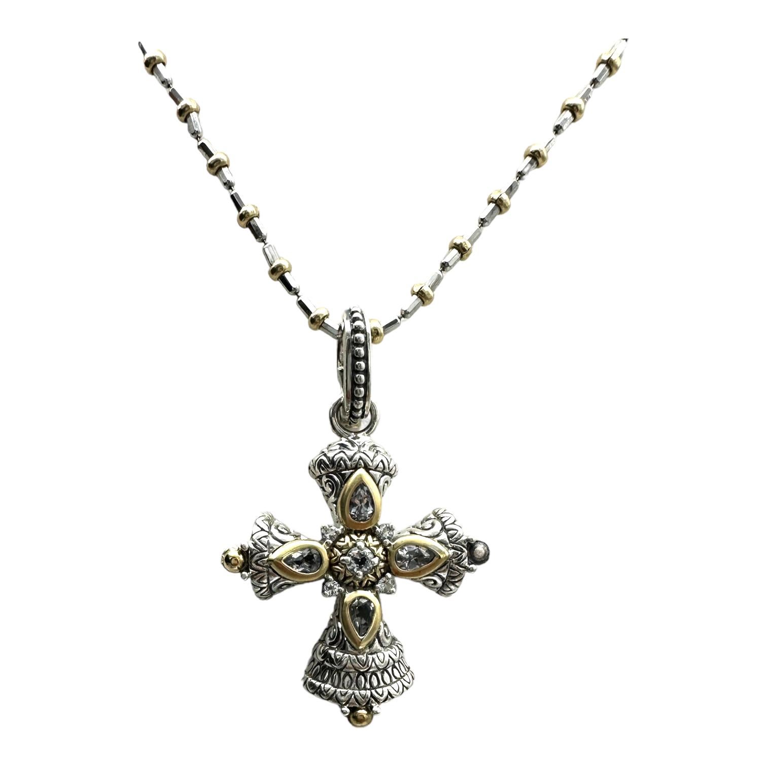 18 Karat Yellow Gold Cross with Sterling. White stones are set in bezels of 18 Karat gold.

The measurements of the cross are 1-3/4” in length, including the ornate .50