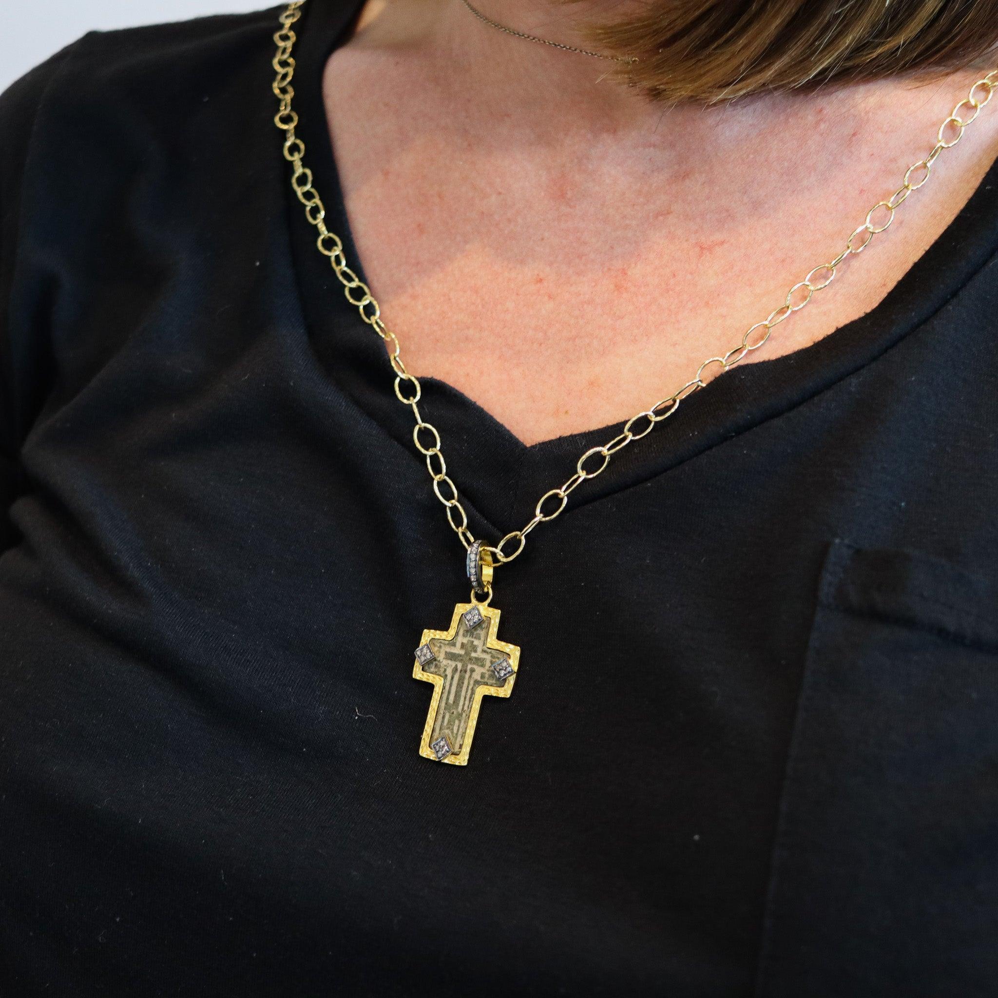 Orthodox cross from the 18th century.

The main center piece of this pendant, is an antique late 18th century archeological Byzantine Orthodox cross, sand casted in solid copper back in the, circa 1780. This antique cross was found in the city of
