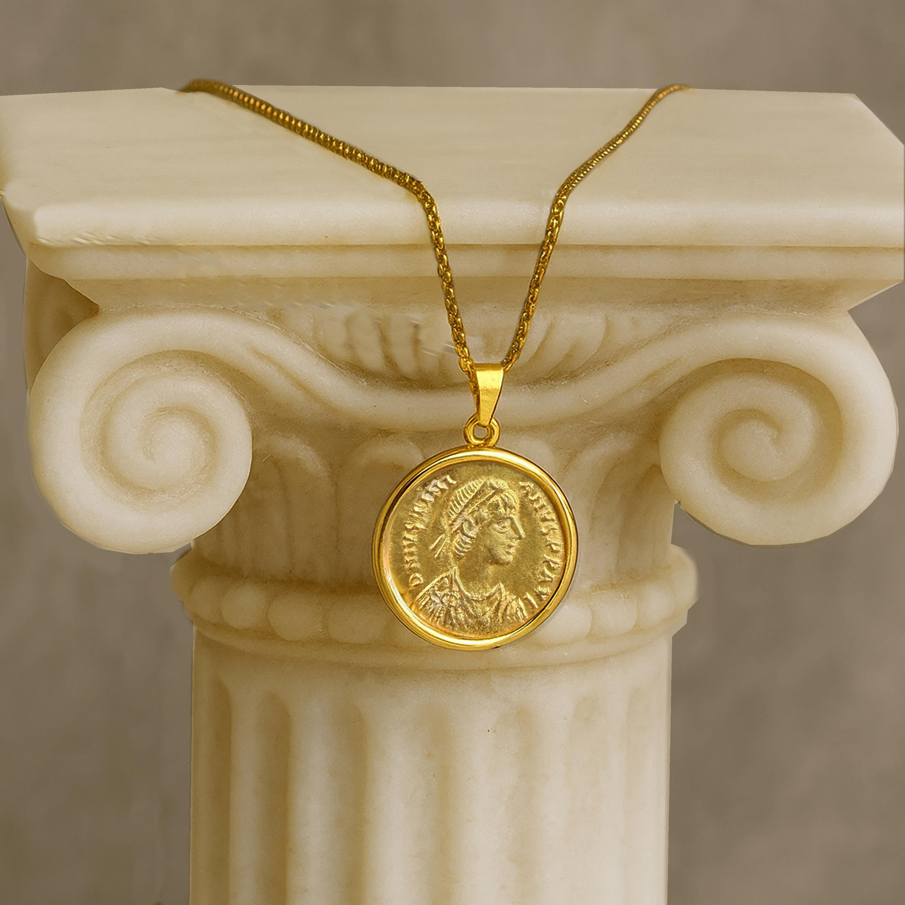 This exquisite 18Kt Gold pendant houses a 24Kt Gold Byzantine coin (Tremissis) 6th Cent AD depicting Emperor Justinian I. On the rear, we can see the Victory holding globus and wreath; star to right.

In the heart of Byzantium, Justinian I ascended