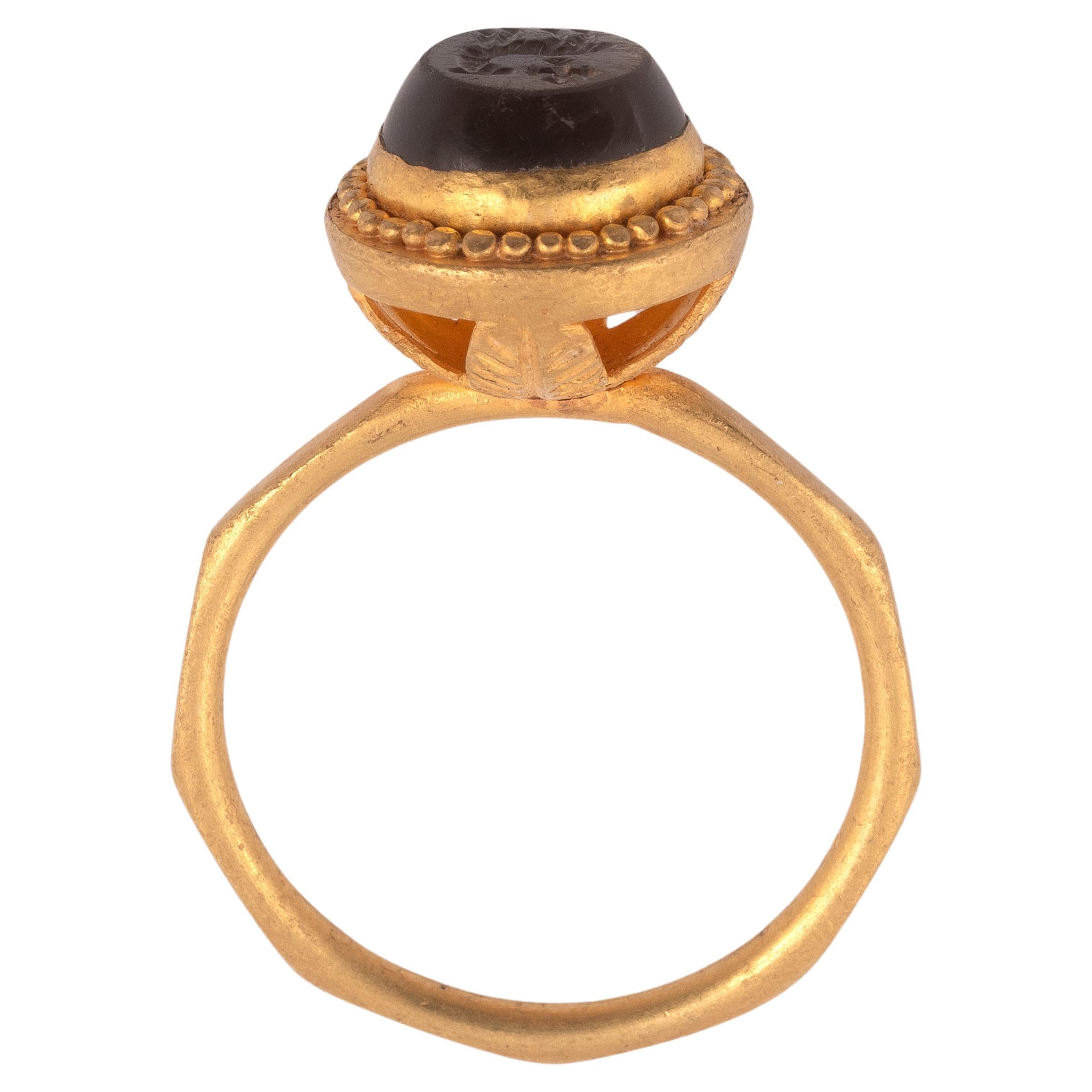 Une bague en or d'architecture byzantine de parfaite qualité, élégante et unique, décorée de filigrane et de granulation. Le chaton est serti d'une citrine en creux représentant l'agneau pastoral et la croix. Ce type de bague est dit 