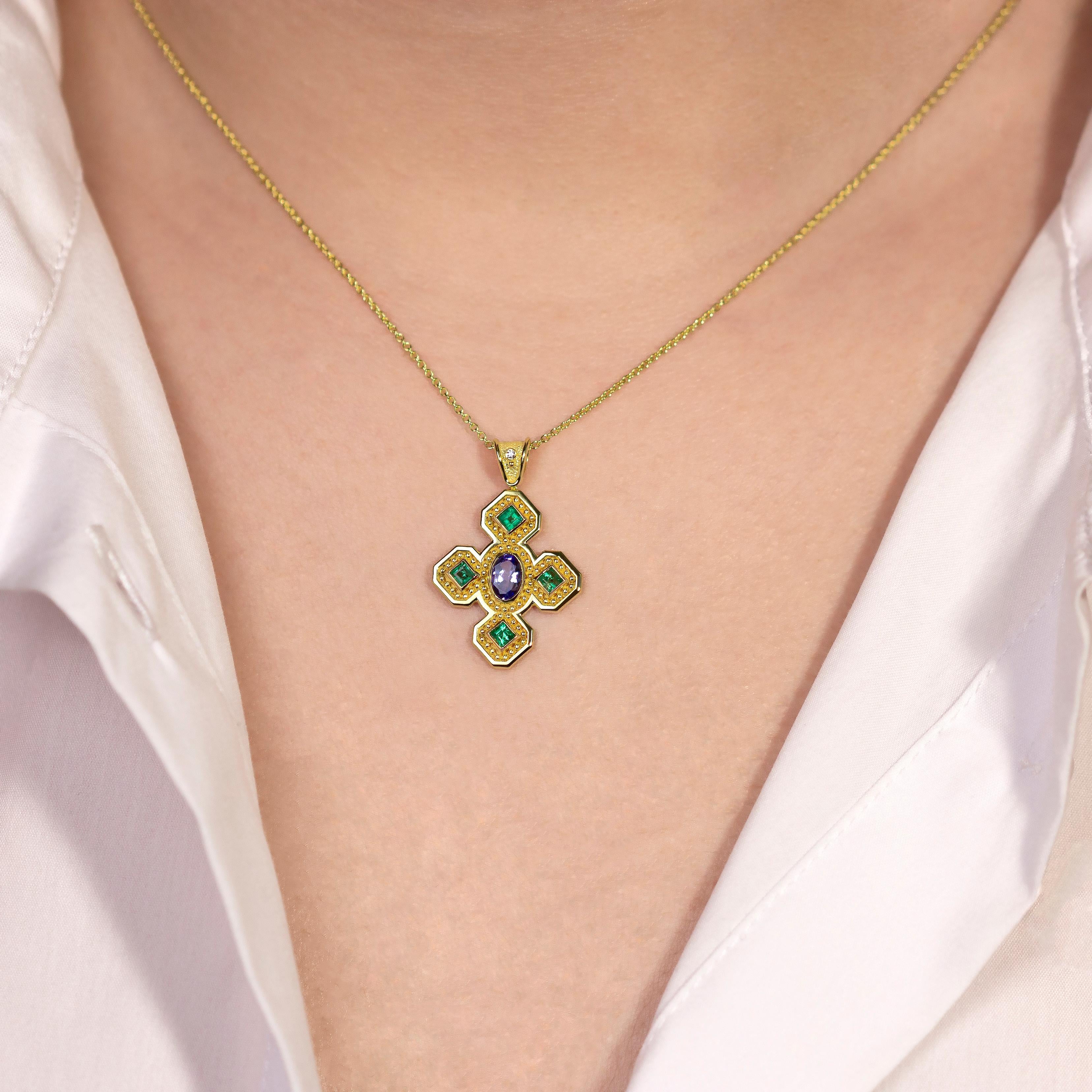 Experience the divine beauty of this Byzantine cross pendant, adorned with exquisite emeralds, tanzanite, and a radiant diamond. This piece is a testament to the rich history and opulence of Byzantine artistry, making it a true masterpiece of your