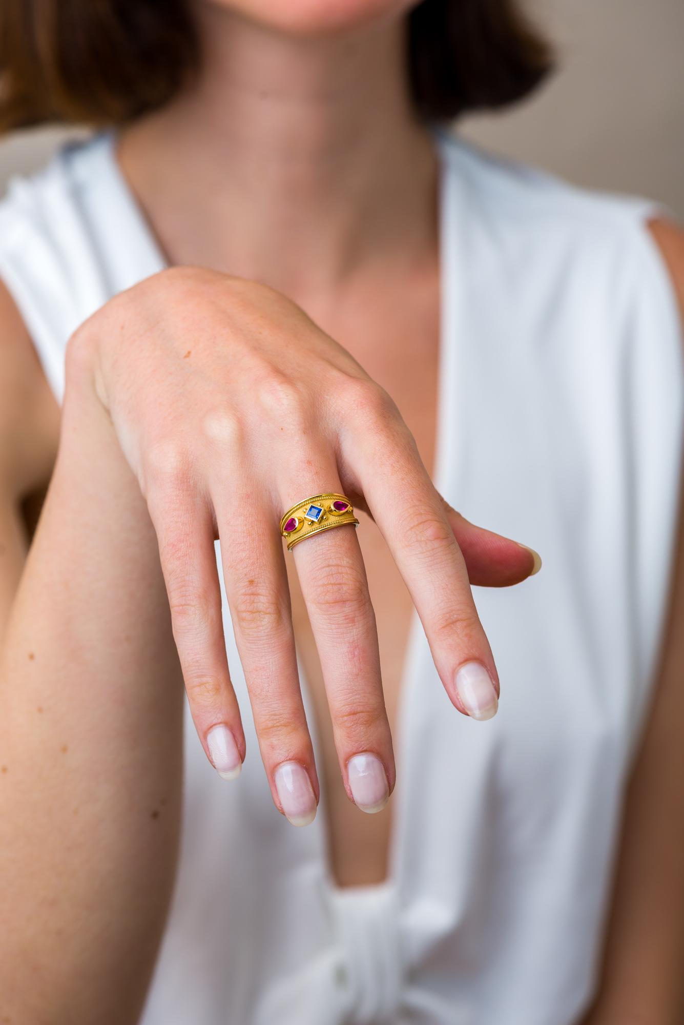 This exquisite gold ring is a captivating canvas, where two pear-shaped fuchsia rubies ignite the imagination, and a square blue sapphire sets the stage for an enchanting tale of vibrant elegance and timeless allure.

100% handmade in our