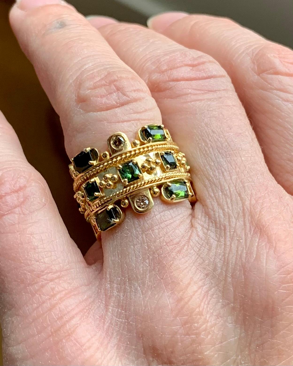 Very attractive 18 K yellow Gold band Ring. The inspriation for this ring comes from the byzantine workmanship. The ring festures 16 green Tourmalines weighing 3.42 ct and 8 brilliant cut Diamonds weighing 0.43 ct. 
The ring is currently size 55/15