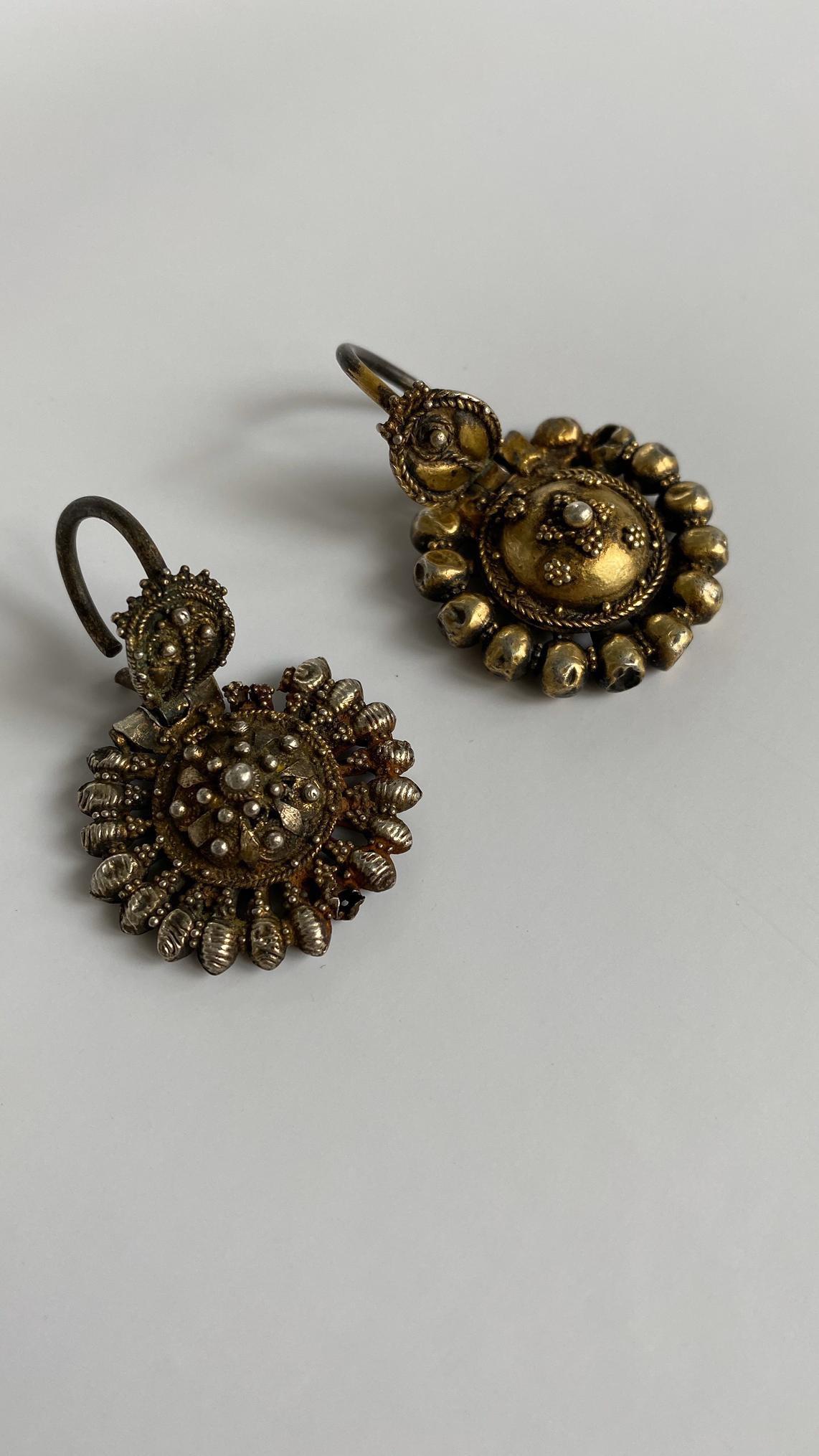 Authentic Pair of earrings ('arpalii) comes from its origin town Vidin in Bulgaria.
Silver-gilt, in the form of a central rosette with applied beadwork, surrounded by a series of rod and bead elements all with pattern grainwork or granulation,
