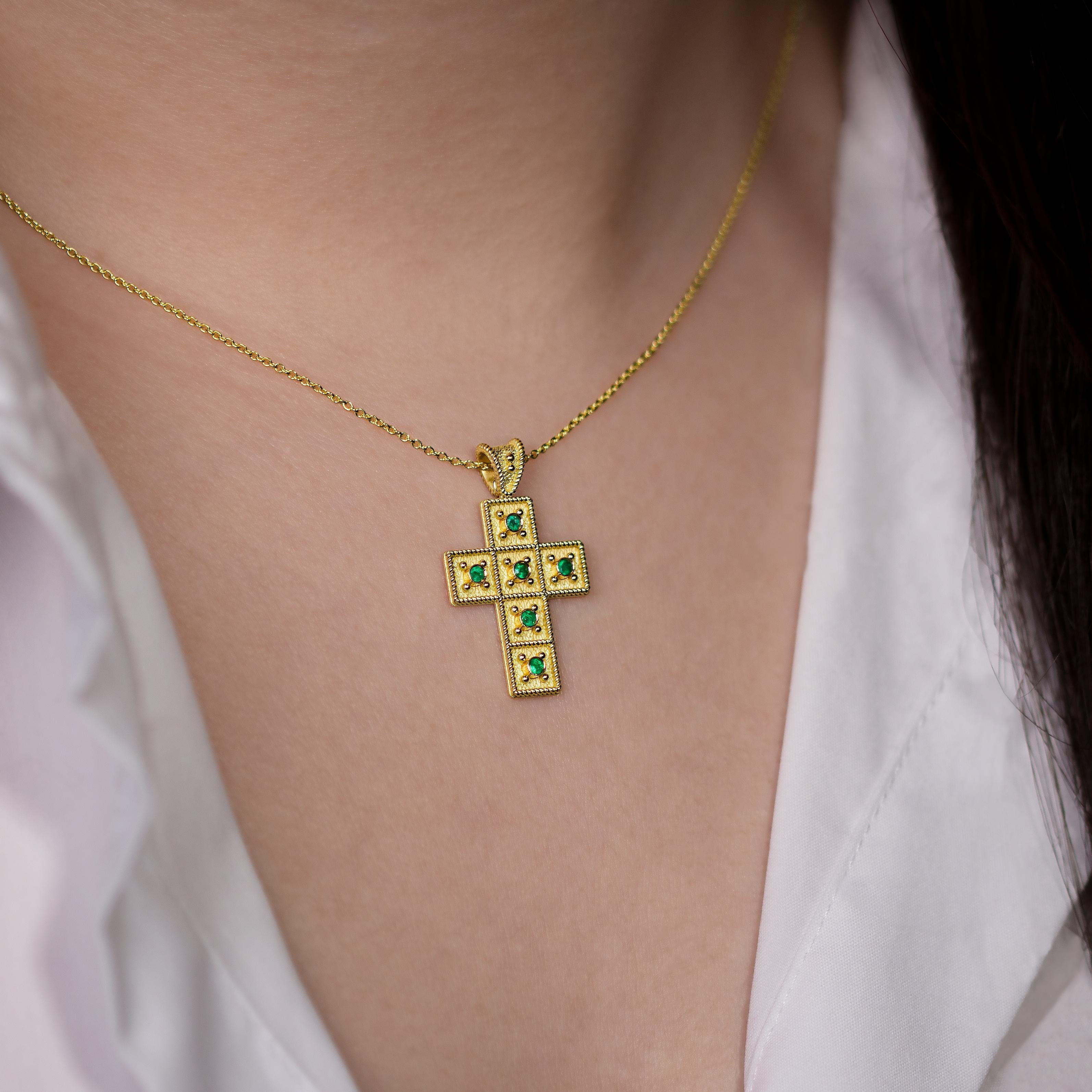 This exquisite gold cross pendant is framed by intricate golden rope detailing, and gracefully adorned with a constellation of sparkling emeralds, forming a symbol of timeless faith and opulent charm that captivates the heart.

100% handmade in our