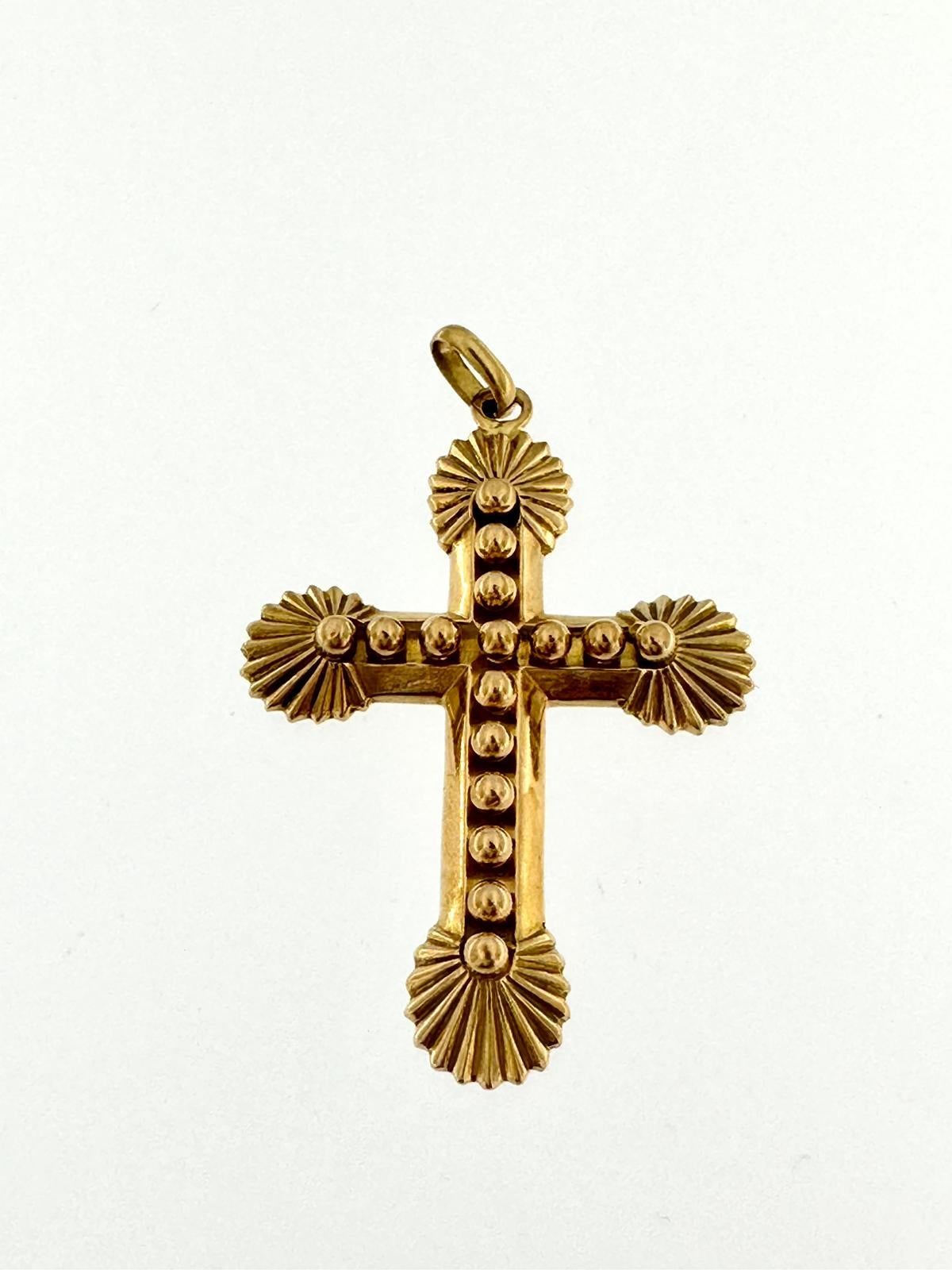 This Cross was crafted in Portugal in 18kt yellow gold. It has an orthodox Byzantine style due to the rounded beams ends. It has a cross-over-the-cross effect because it is decorated on the front with small spheres that form a cross. This type of