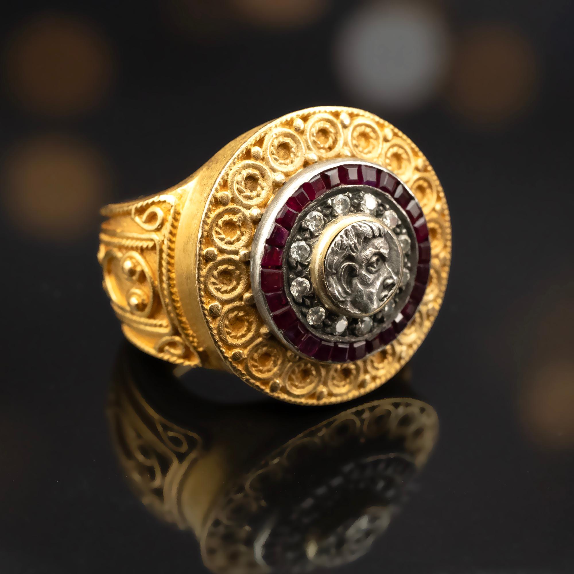 Handmade in rich 22 Karat gold, this Byzantine style ring boasts an impressive weight of 27 grams, lending a substantial feel to your ensemble. A portion of an antique coin, set in silver, takes center stage, encircled by diamonds and then a circle