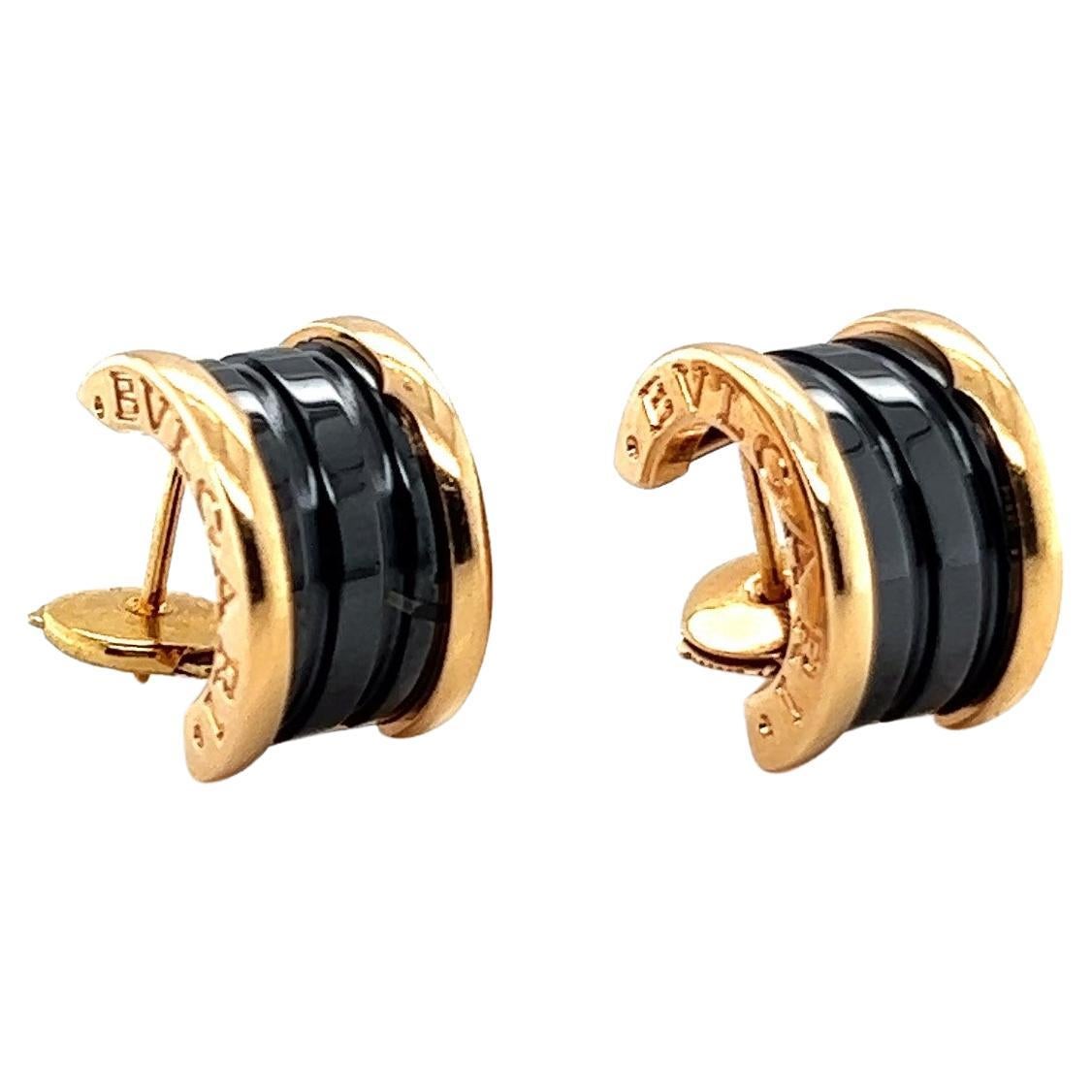 Discover the subtle allure of Bzero1 Hoop Earrings by Bvlgari – a seamless blend of grace and ingenuity. Fashioned from lustrous 18 Karat rose gold, these earrings boast two enigmatic chalcedony black gems, adding a hint of allure to this piece.