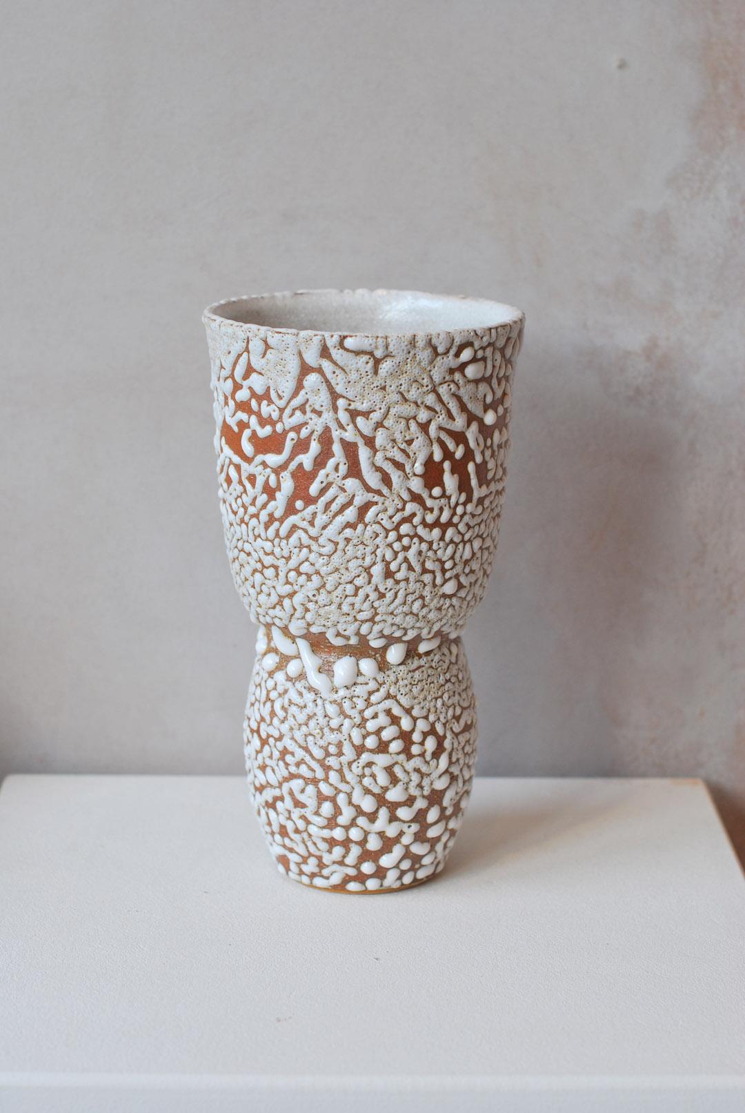 C-019 white stoneware vase by Moïo Studio
Dimensions: D12 x W12 x H21 cm
Materials: White crawl glaze on tan stoneware
Made by hand on the wheel
Unique piece, consult for multiples

Is the Berlin-based ceramic art studio of French-Palestinian