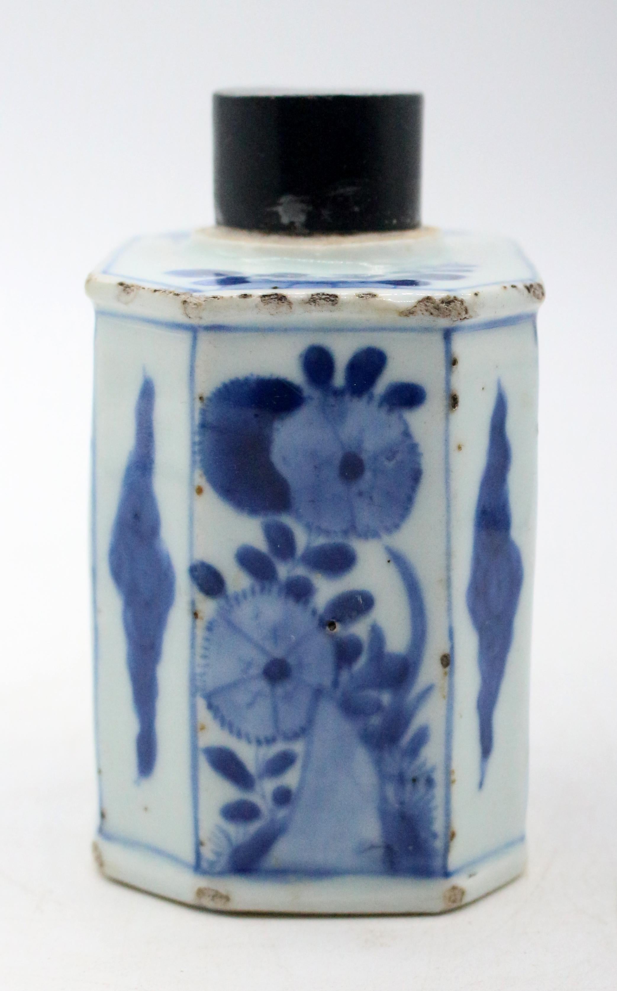 Circa 1720s Kangxi or Yongzheng period porcelain tea caddy, Chinese. 8-sided porcelain body with later tole cover. Blue & white; floral decoration with chrysanthemums & butterflies. Rough edges & corner chip typical for age & use.
3.5
