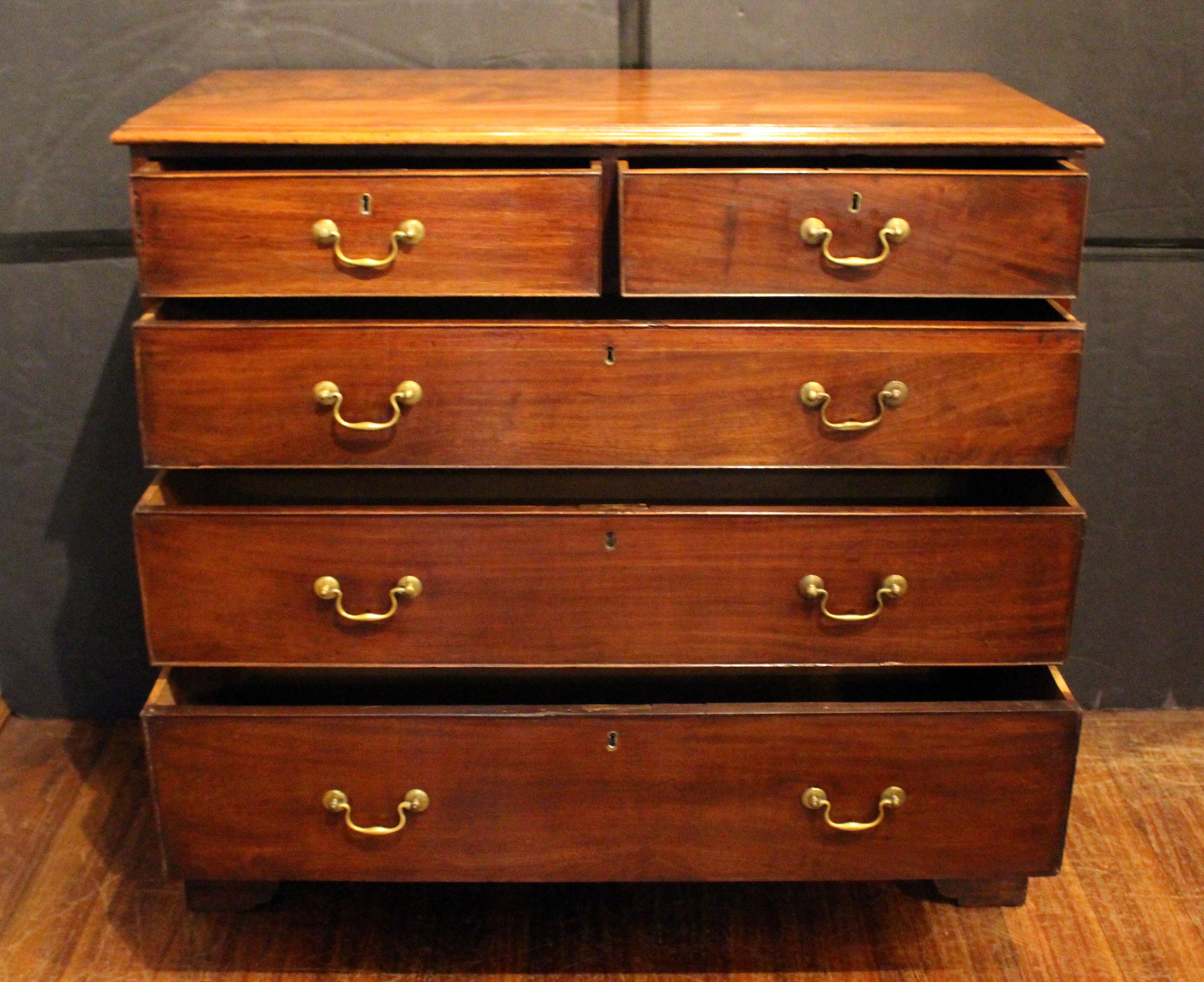 Circa 1760-70 George III Chippendale style chest of drawers, English. Two short over three long graduated drawers. Original brass bail & rosette pulls. Raised on bold, shaped bracket feet. Well figured top with molded edge. Mahogany. Cockbeaded