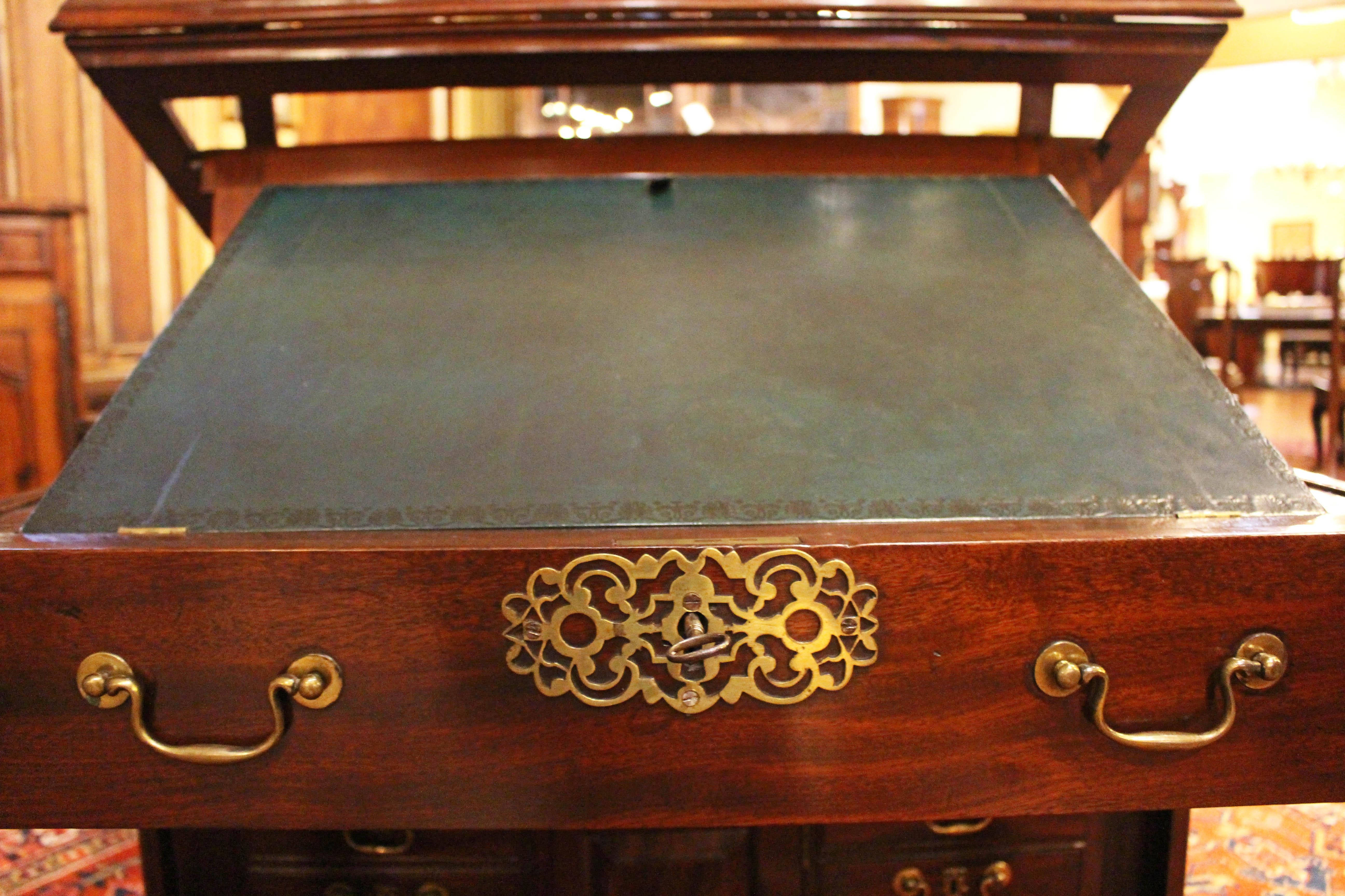 Circa 1765 George III period Gentleman's Library Writing Table Chest, English. Folio stand or drawing stand rising writing surface. Each side with 14 drawers surrounding a paneled door revealing 8 collector drawers (28 drawers & 16 collector drawers