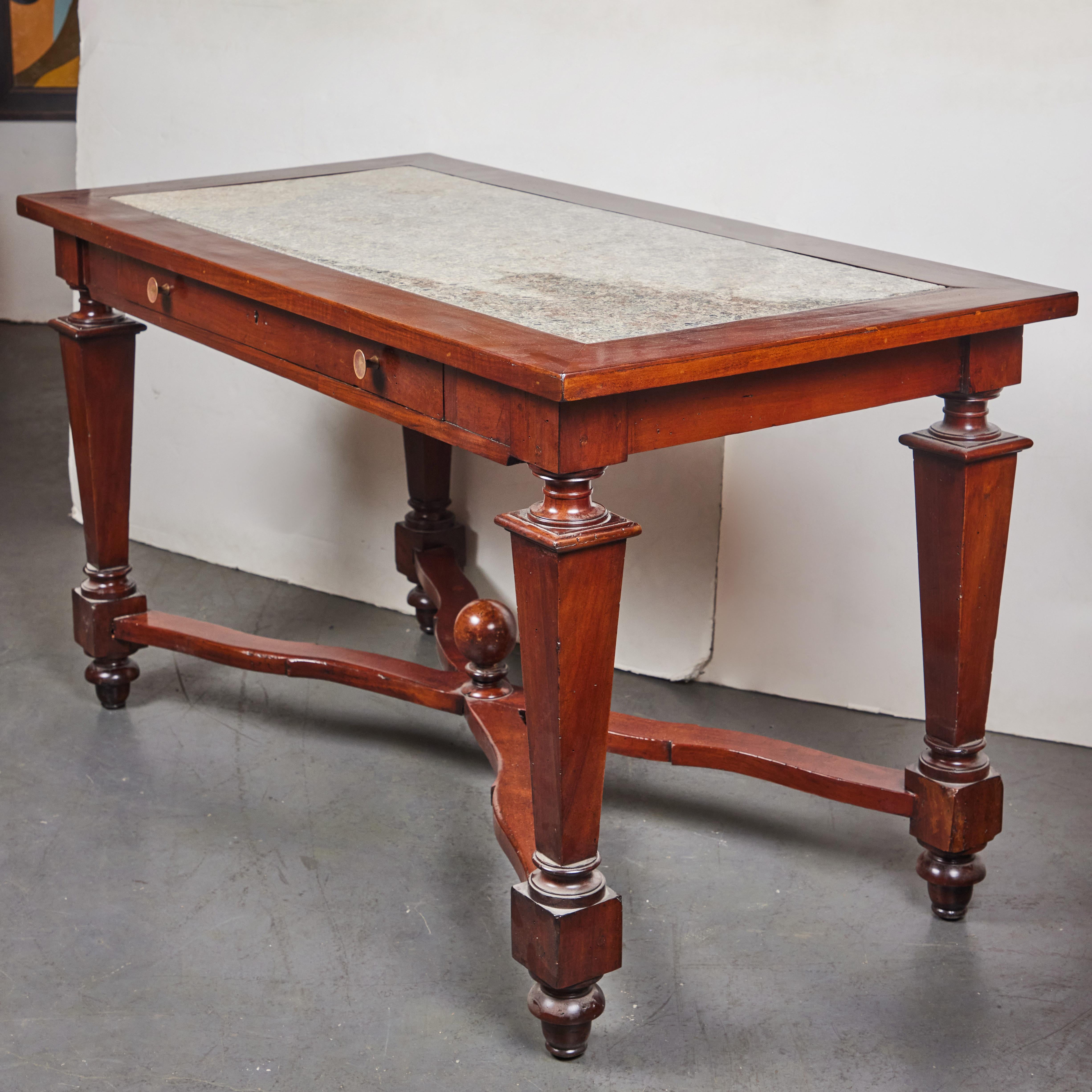 A hand-carved, solid walnut, single drawer, Tuscan console table. The top featuring it's original, marble slab sits above four tapering, turned legs and feat braced by a serpentine x-stretcher centered on a sphere finial.