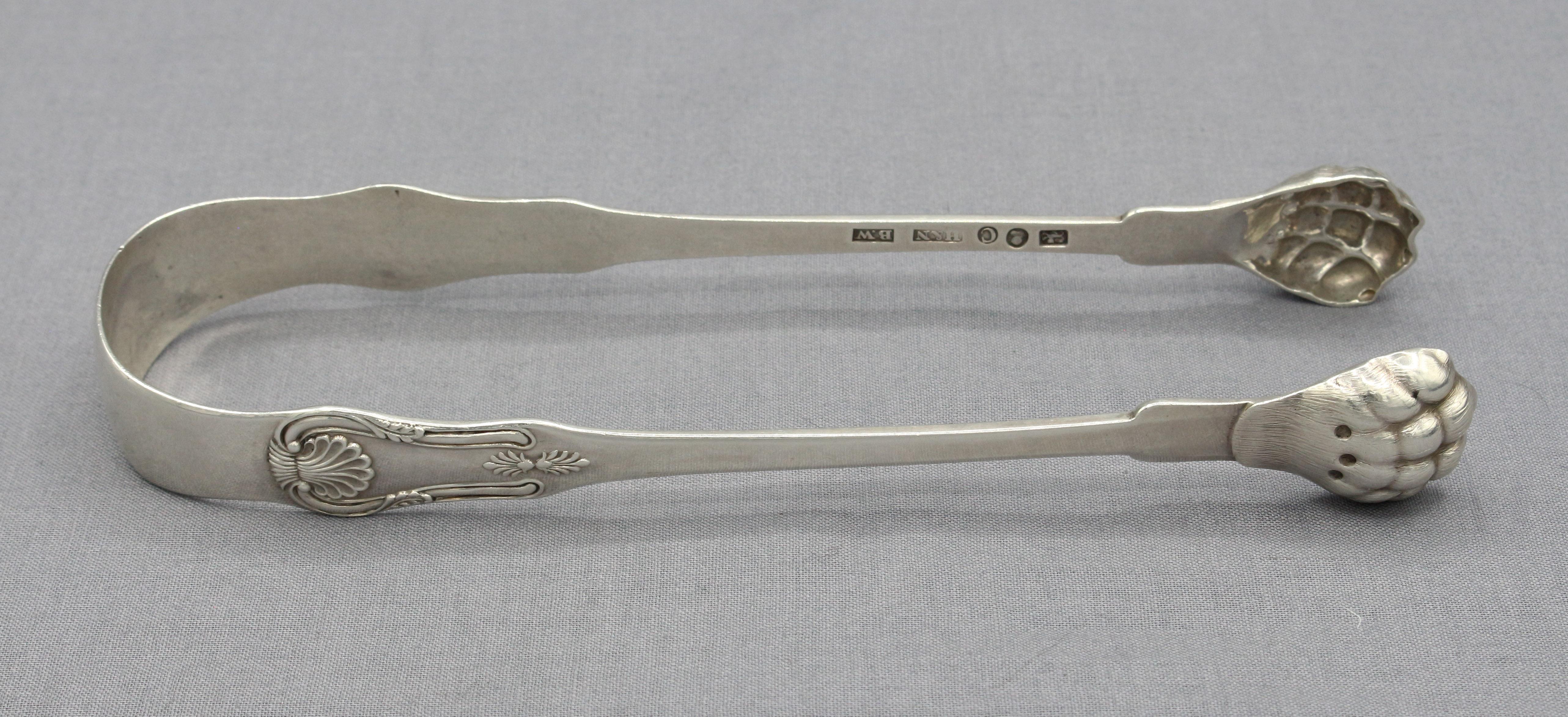 Fiddle shell pattern coin silver sugar tongs, circa 1815, American. Made by William Thompson, Henry Salisbury & George Eoff of NYC (lion, bust & C marks), retailed by Hyde & Nevins, New York. Exceptional quality with hairy paw ends. Also marked WB