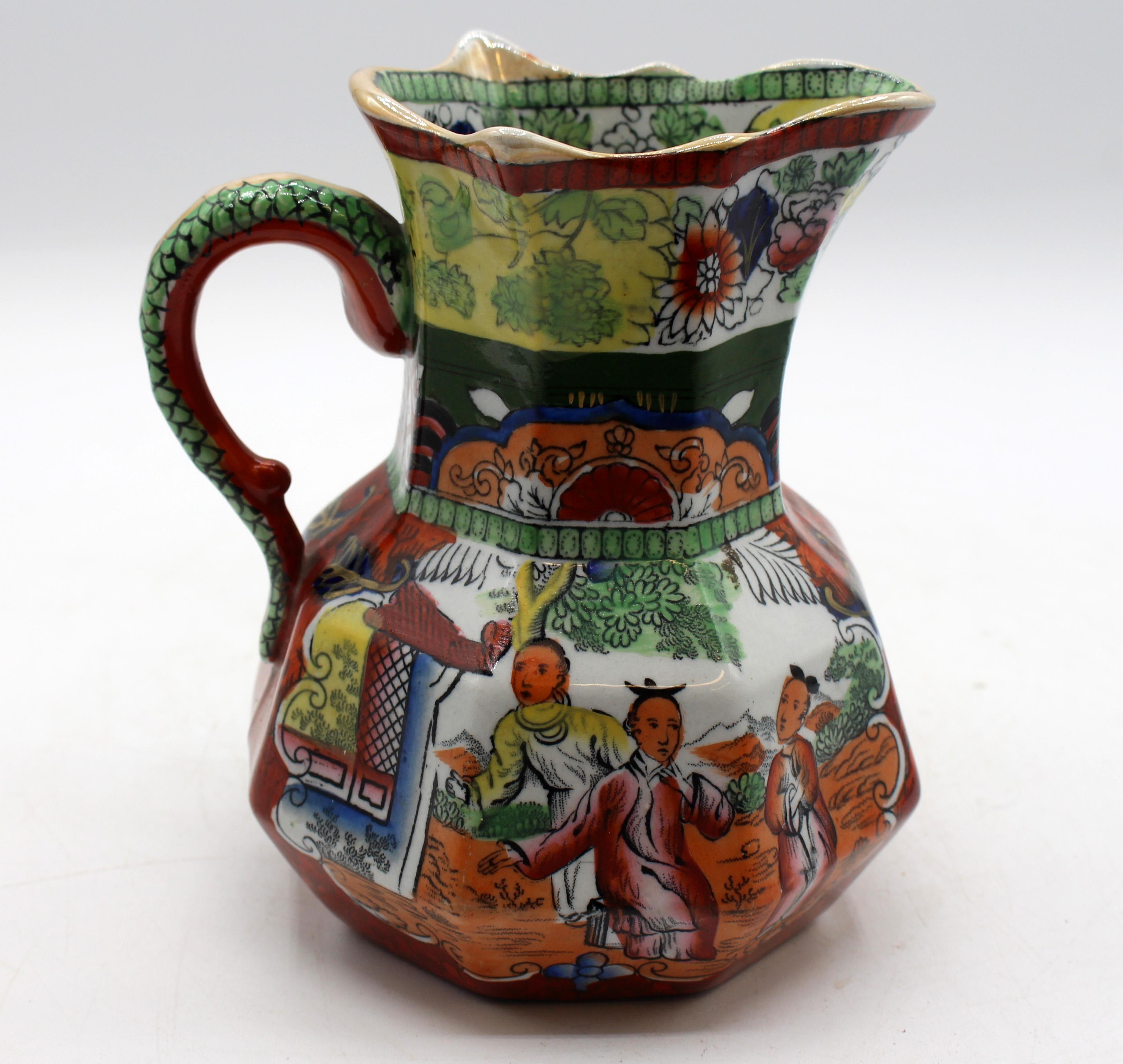Circa 1830-48 large Mason's ironstone hydra scale Chinoiserie jug or pitcher, English. Marked in black: Mason's Patent Ironstone China; with swag banner & crown. Octagonal with hydra handle. A conversation group on each side by a tea house. Burnt