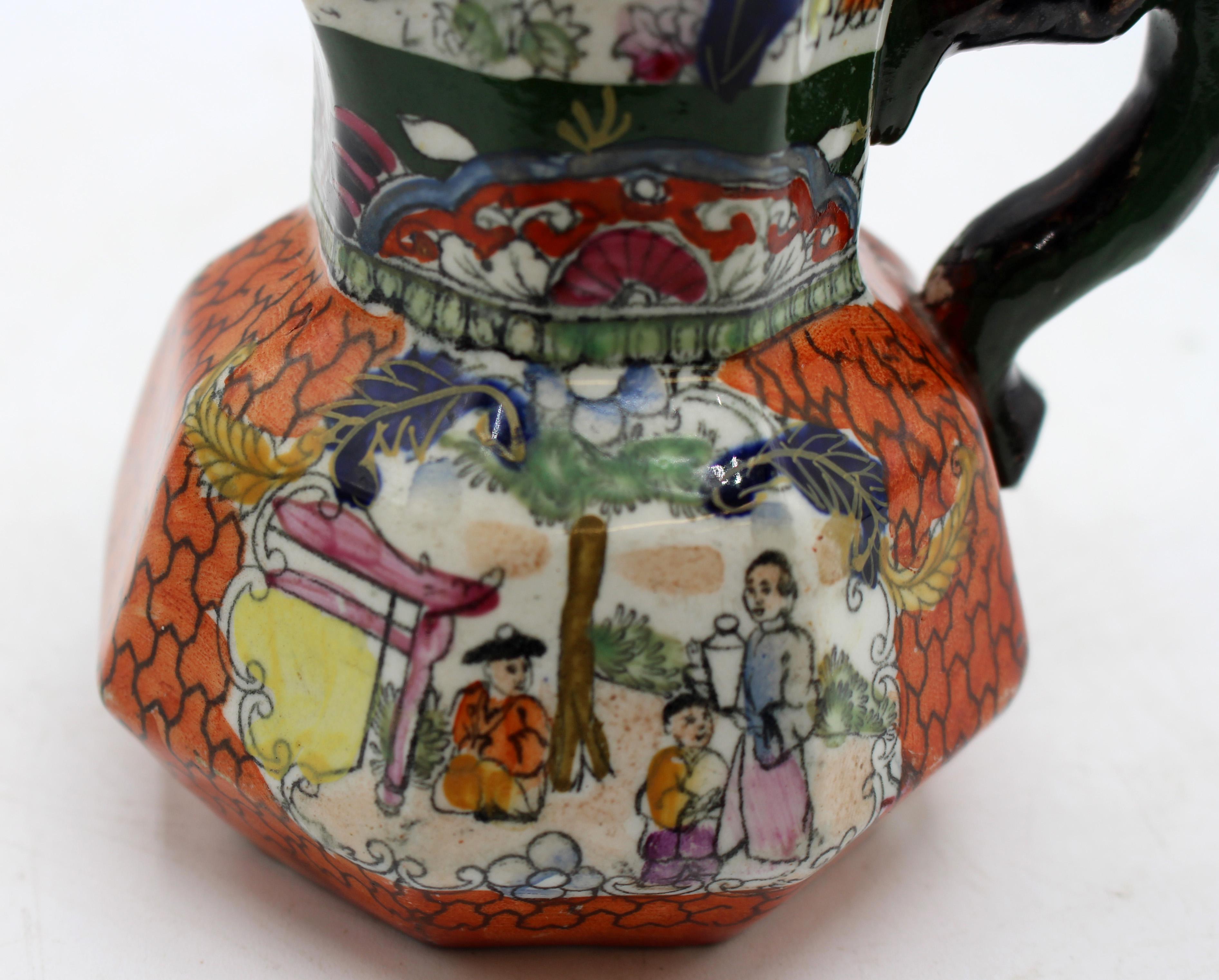 Circa 1830-48 small Mason's ironstone red scale Chinoiserie jug or pitcher, English. Marked in black: Mason's Patent Ironstone China; with swag banner & crown. Octagonal with twig handle. A conversation group on each side by a tea house. Burnt