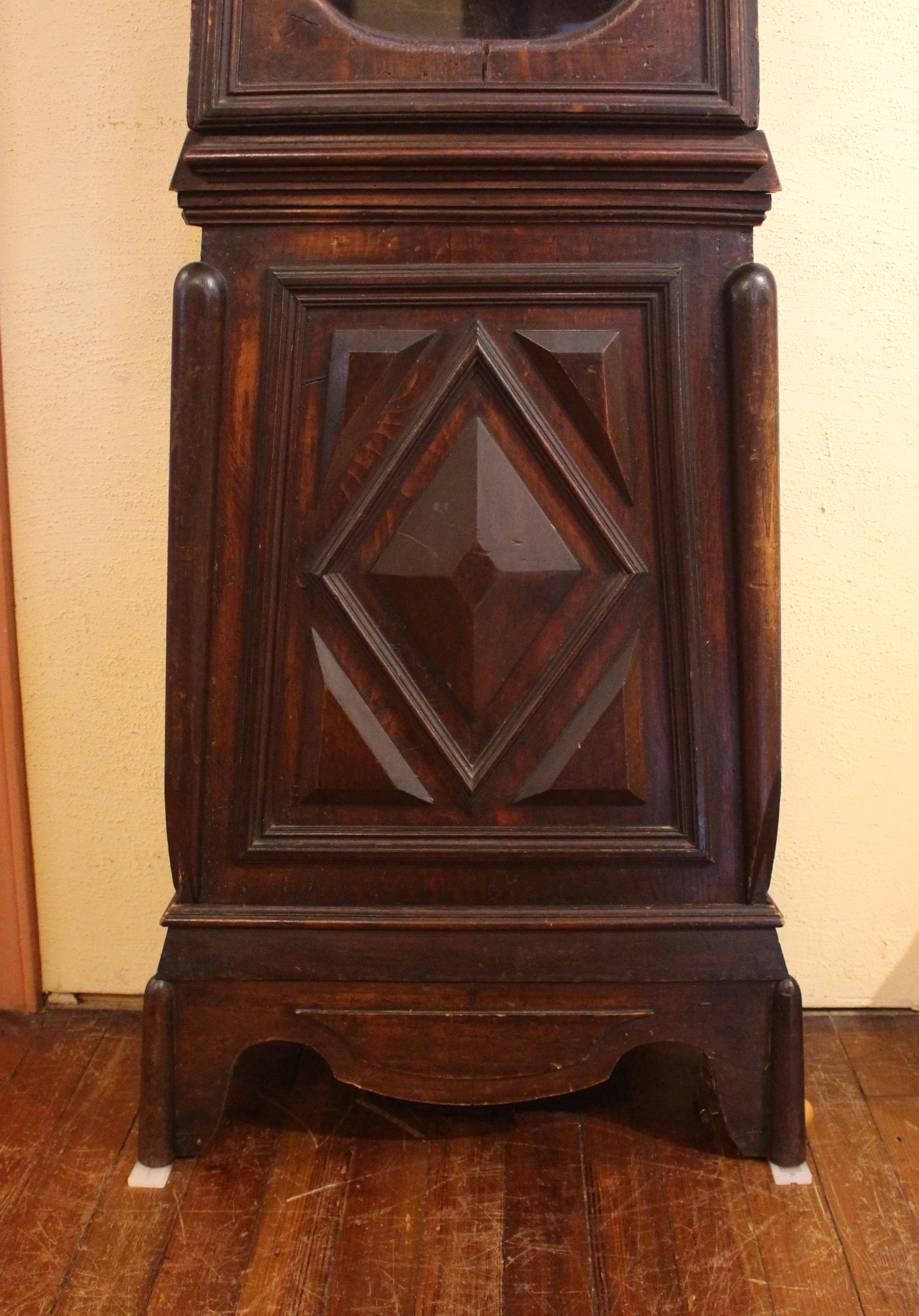 Circa 1830-60 country French morbier tall case clock. Walnut & pine, original finish of a deep, rich color. Diamond panels reflect early 18th century design revived in the 19th century. Gentle chapeau de gendarme crown molding. The enamelled face is